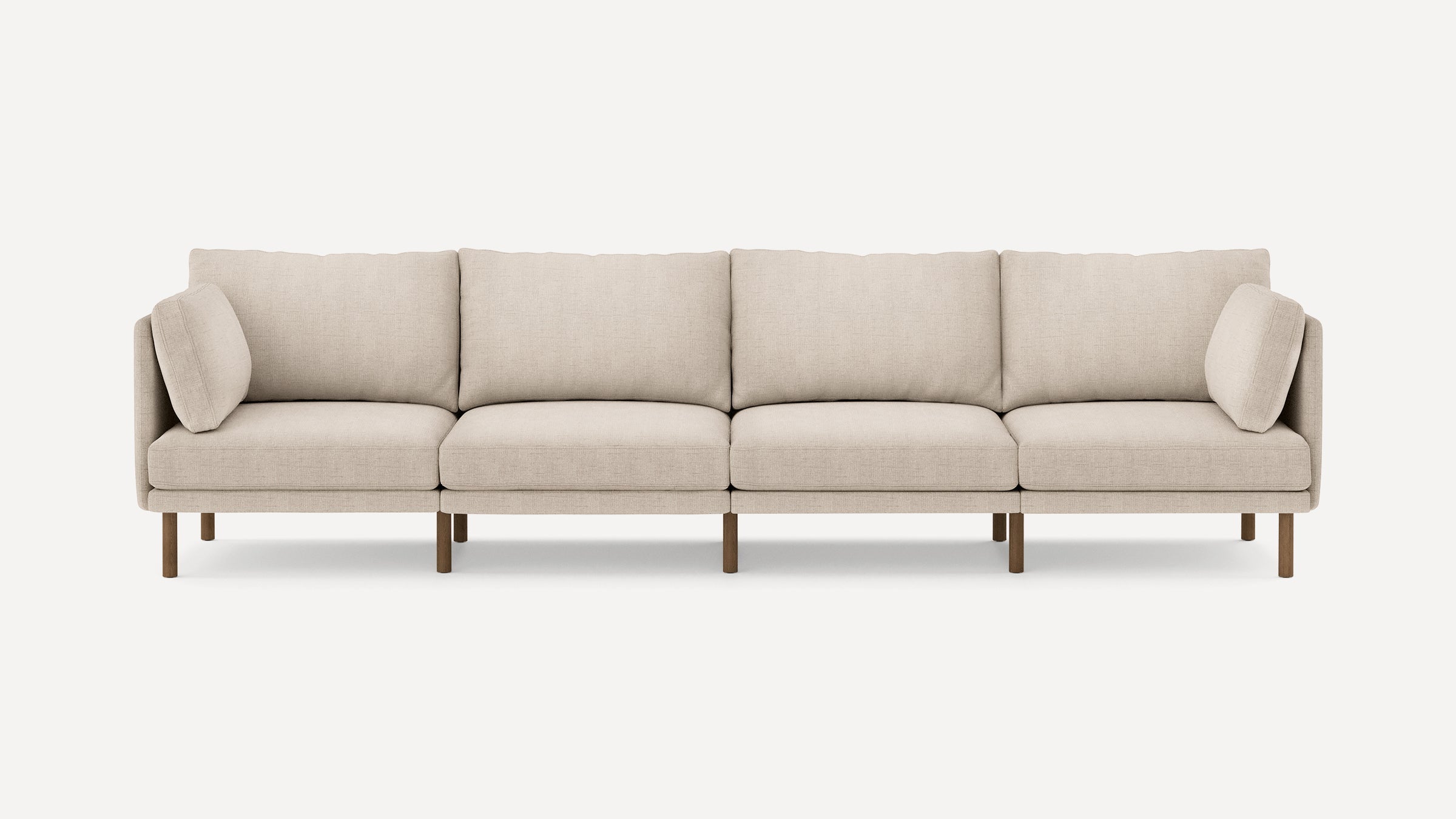 Beige modern sectional sofa with wooden legs and clean lines, featuring four seat cushions and two side pillows.
