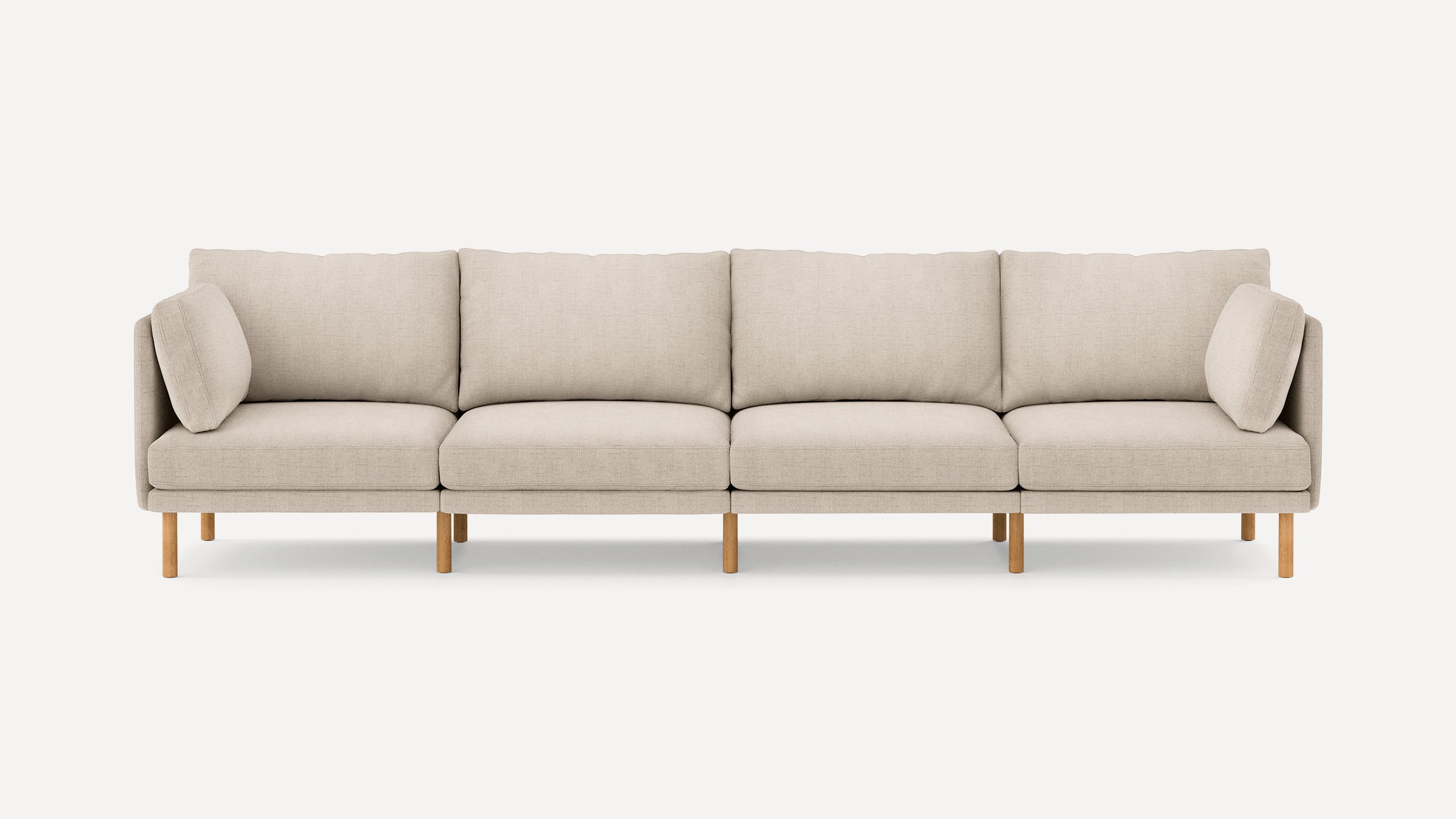 Beige fabric modern sectional sofa with wooden legs, featuring removable cushions and a minimalist design.