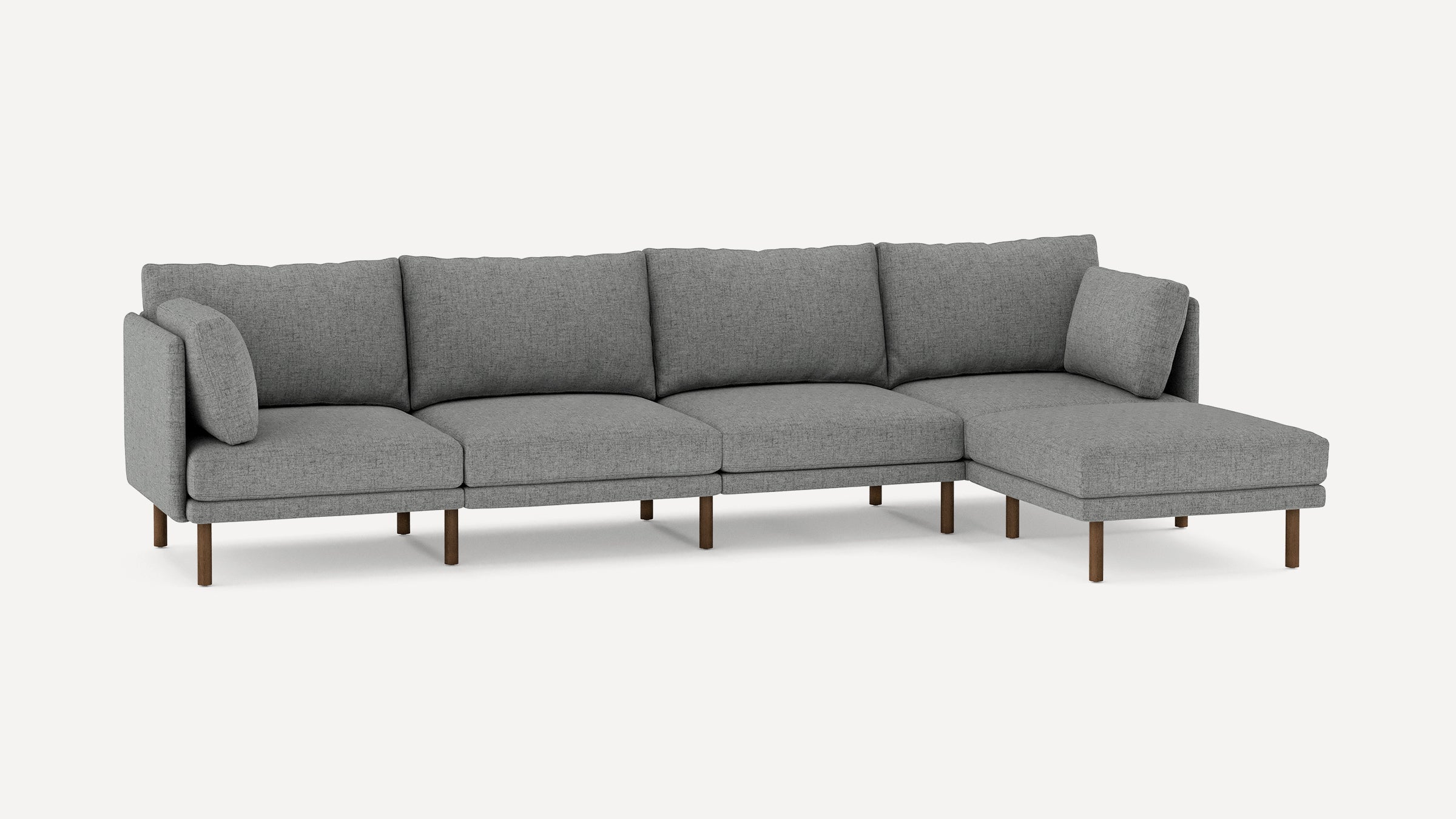 Modern gray fabric sectional sofa with wooden legs, a left armrest, and an extended chaise lounge on the right side.