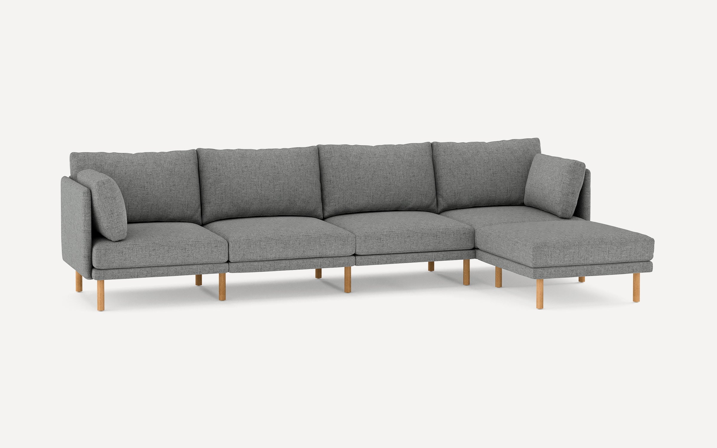 Gray fabric L-shaped sectional sofa with wooden legs and loose back cushions, designed for modern living spaces.