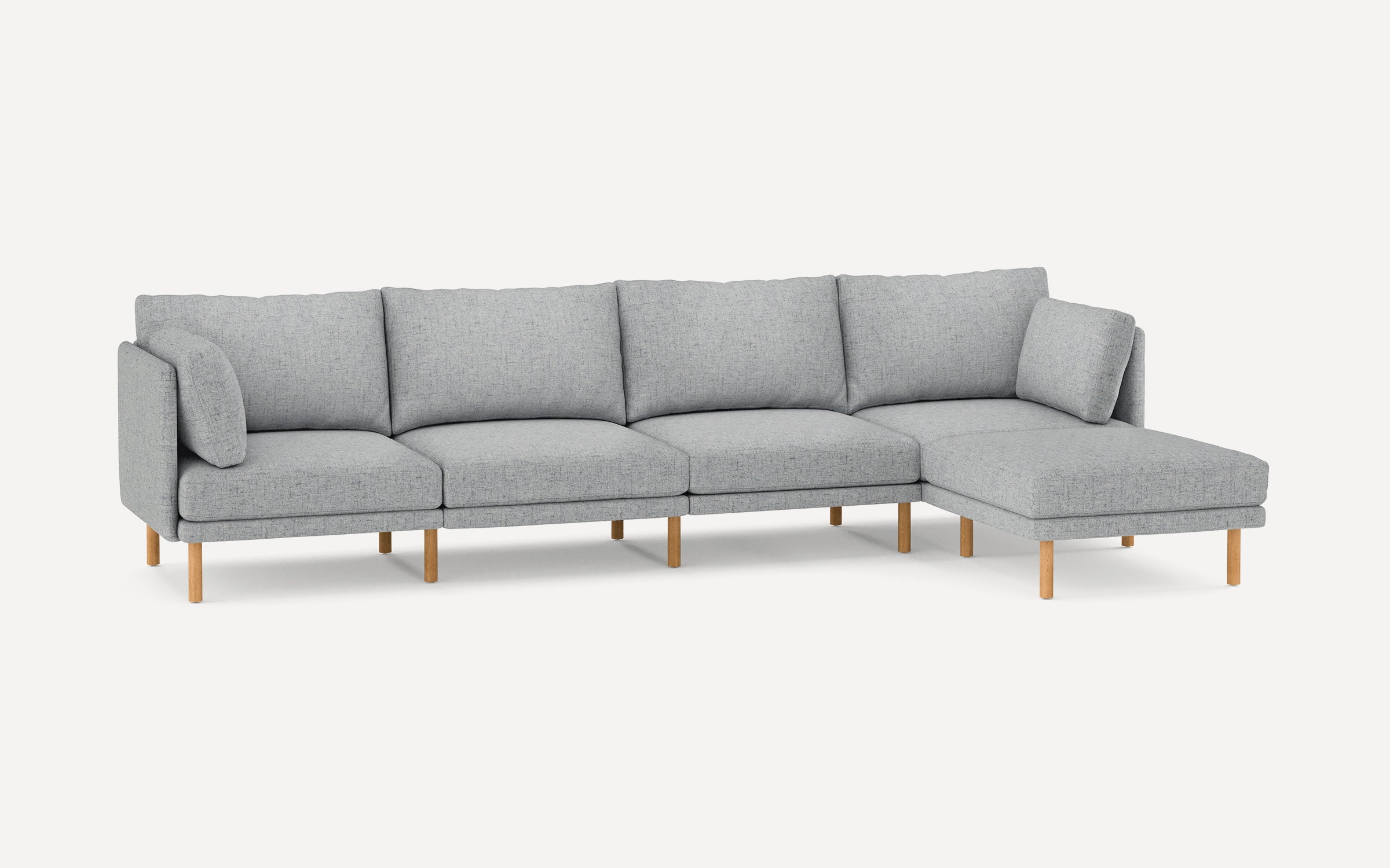 Modern light gray fabric sectional sofa with wooden legs and multiple cushions, featuring a right-side chaise lounge.