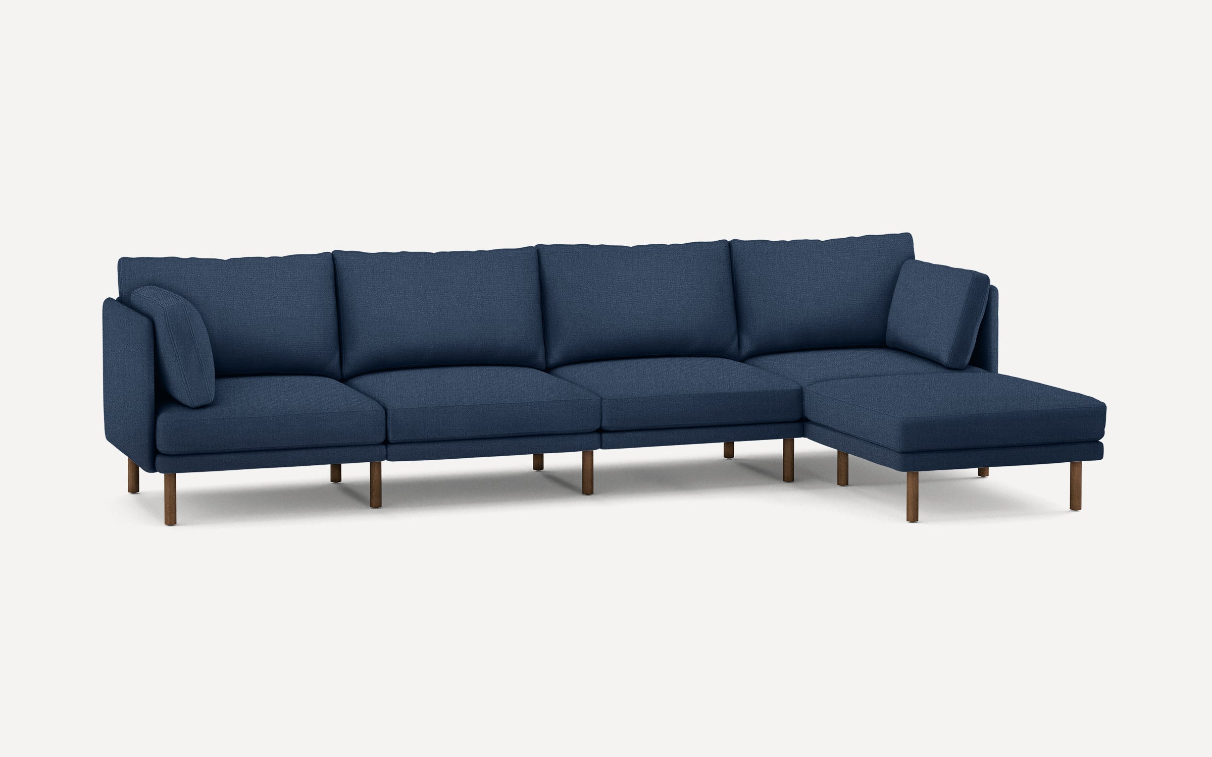 Modern navy blue sectional sofa with chaise lounge and wooden legs, featuring plush cushions and a minimalist design.