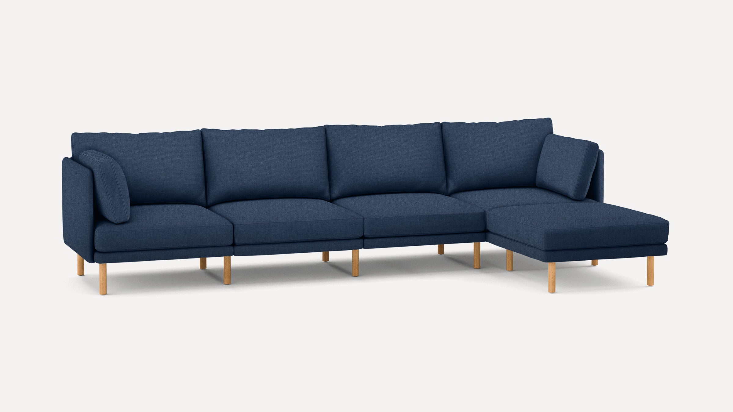 Modern L-shaped sectional sofa with navy blue fabric upholstery, wooden legs, and removable cushions for added comfort.