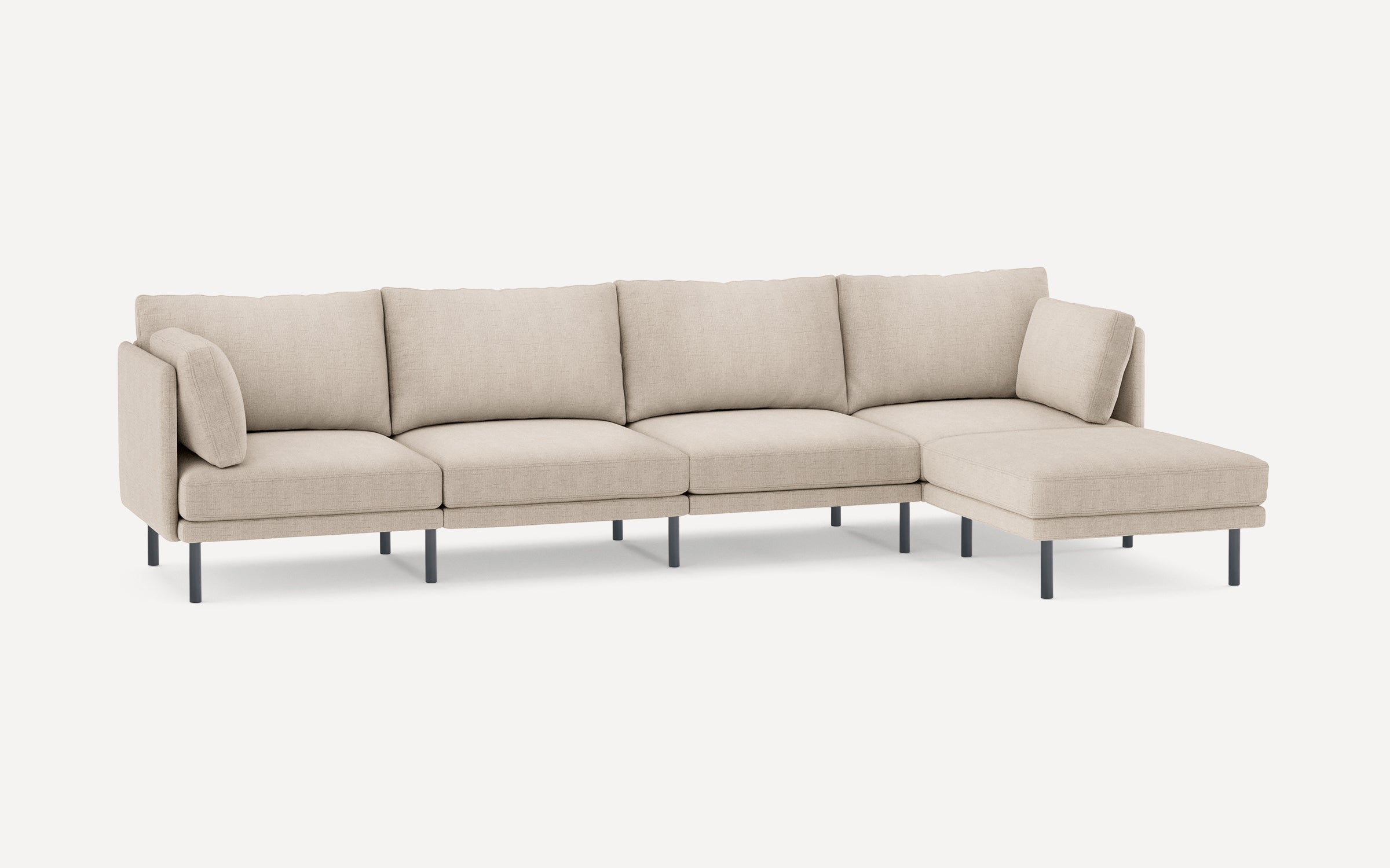 Beige modern L-shaped sectional sofa with metal legs and five seat cushions, including attached chaise lounge on the right side.