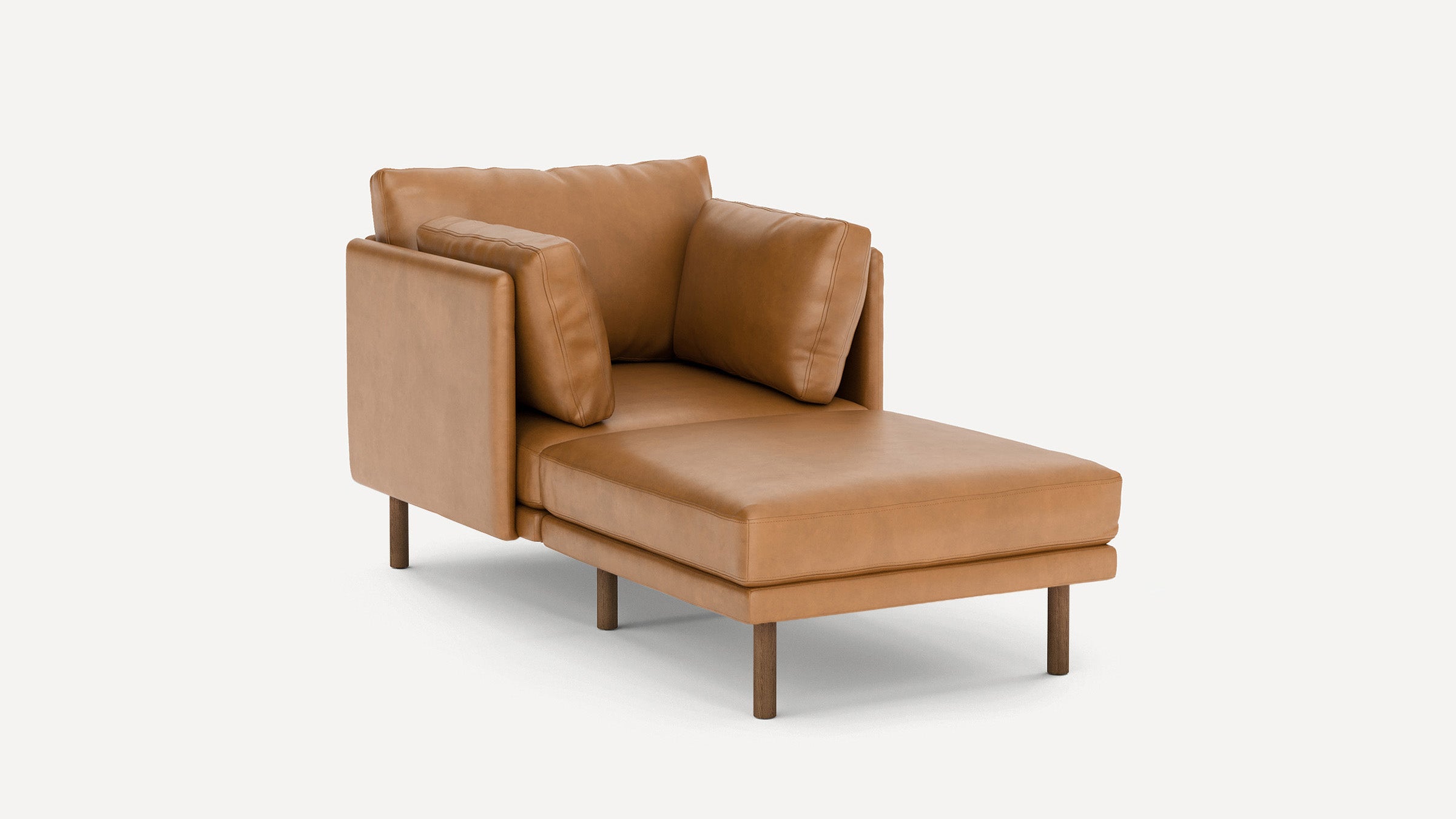 Modern tan leather chaise lounge with wooden legs, featuring a backrest and two matching cushions for comfort.