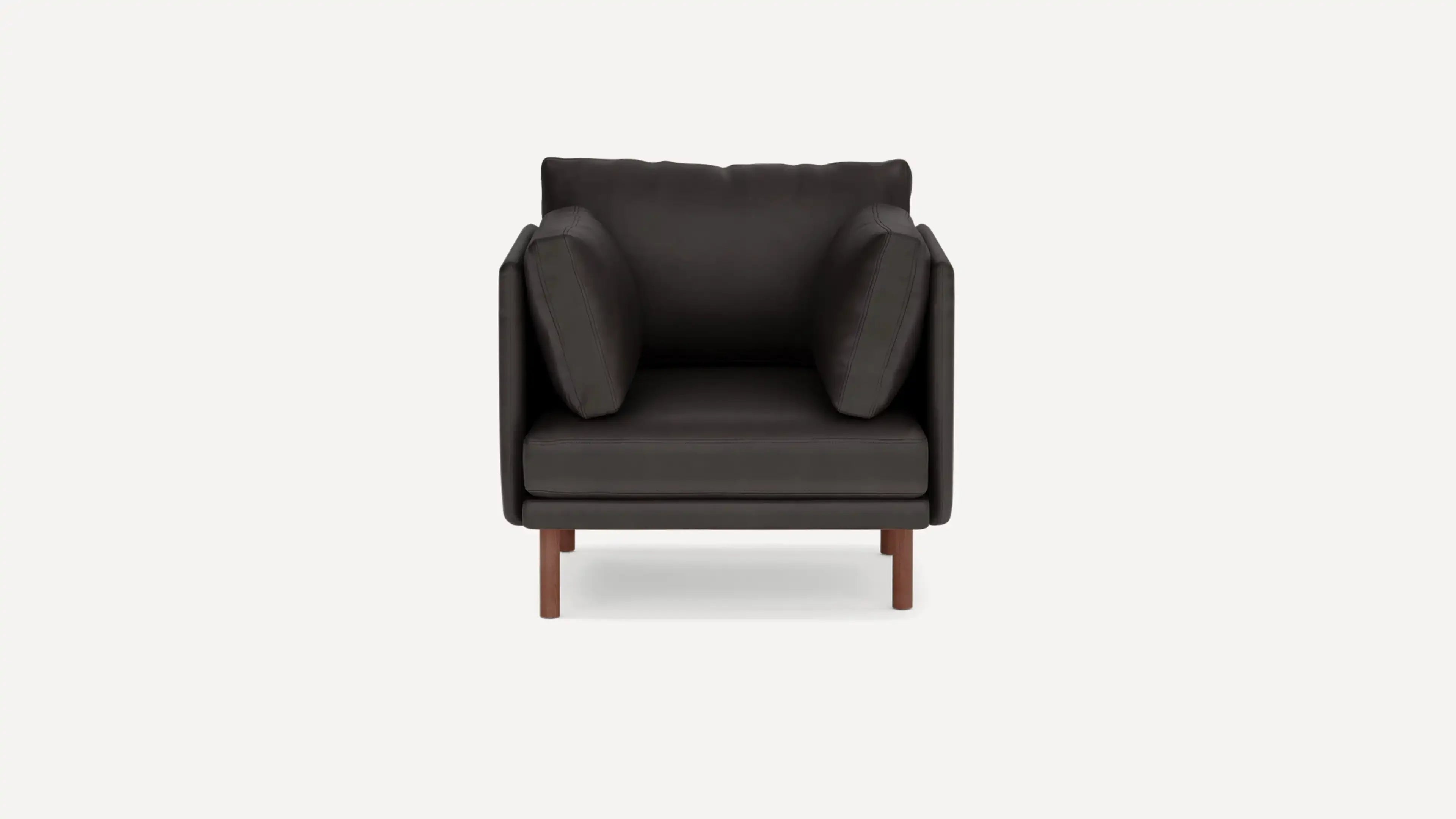 modern black leather armchair with wooden legs and a dark upholstered backrest