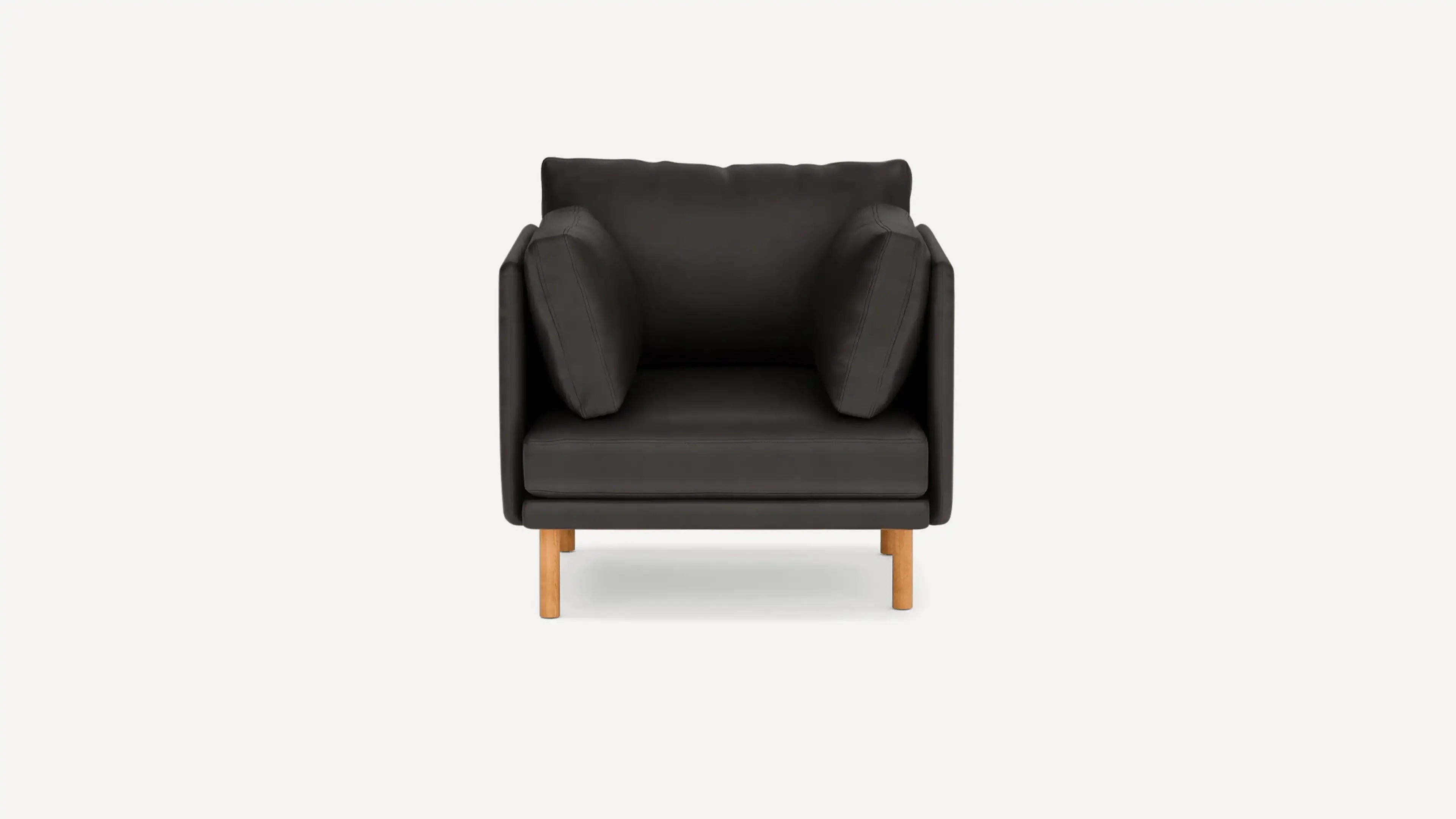 modern black leather armchair with wooden legs and a soft cushion on the back, featuring a soft cushion and a soft cushion on the back