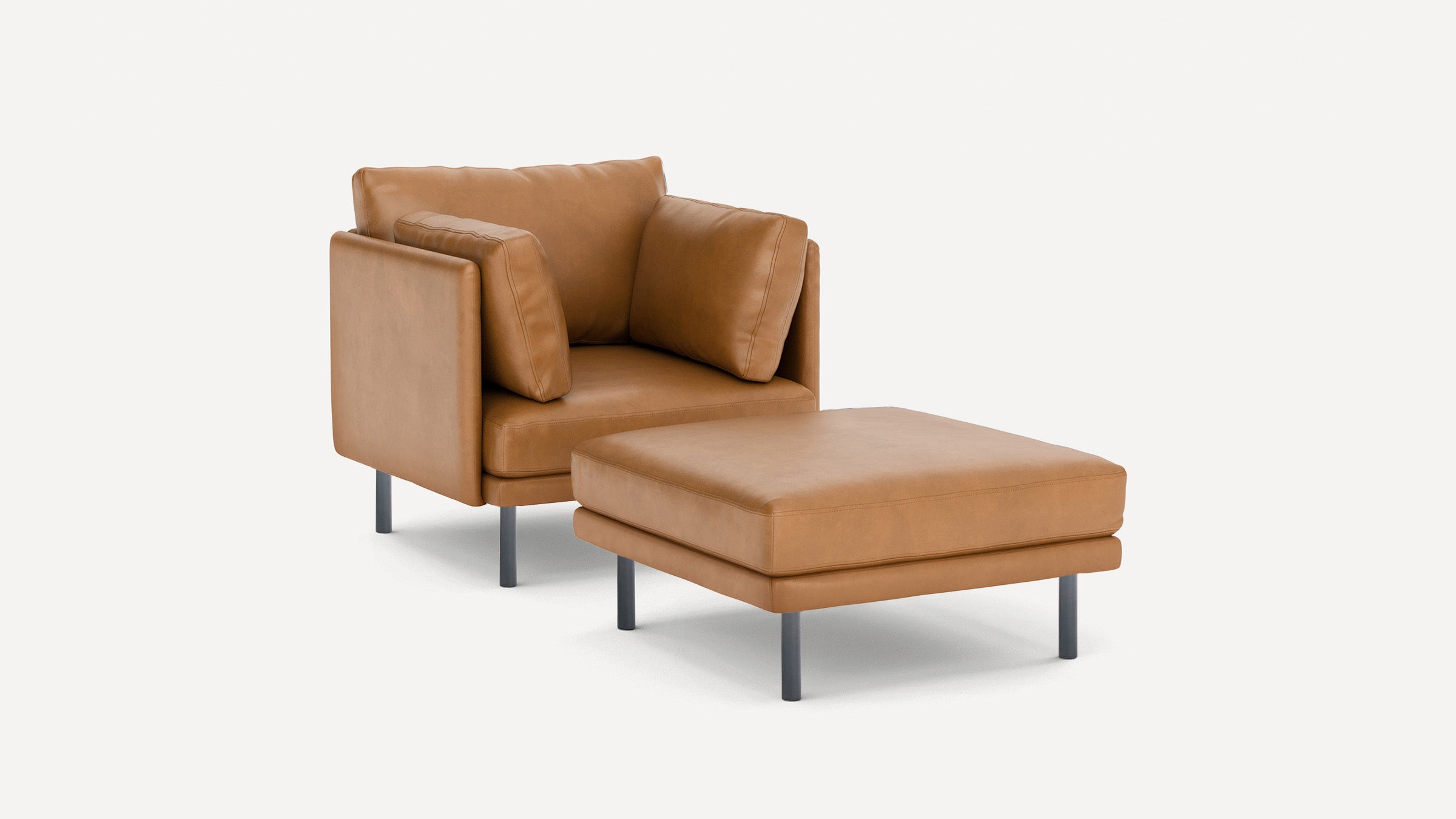 Modern tan leather armchair with matching ottoman, both featuring slim black legs and plush cushions, set against a white background.