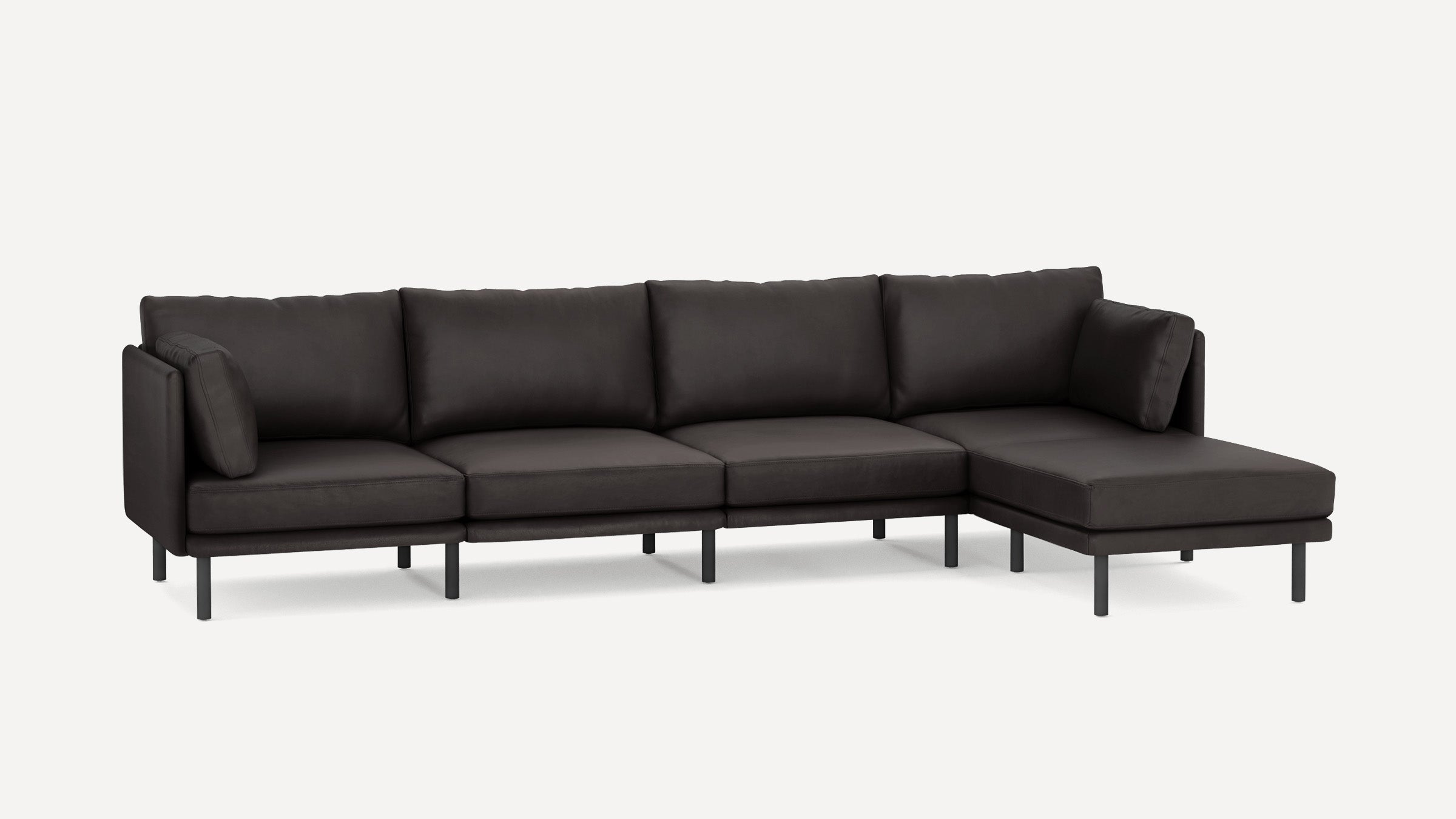 Modern dark gray sectional sofa with a chaise lounge on the right side and slim black legs on a white background.