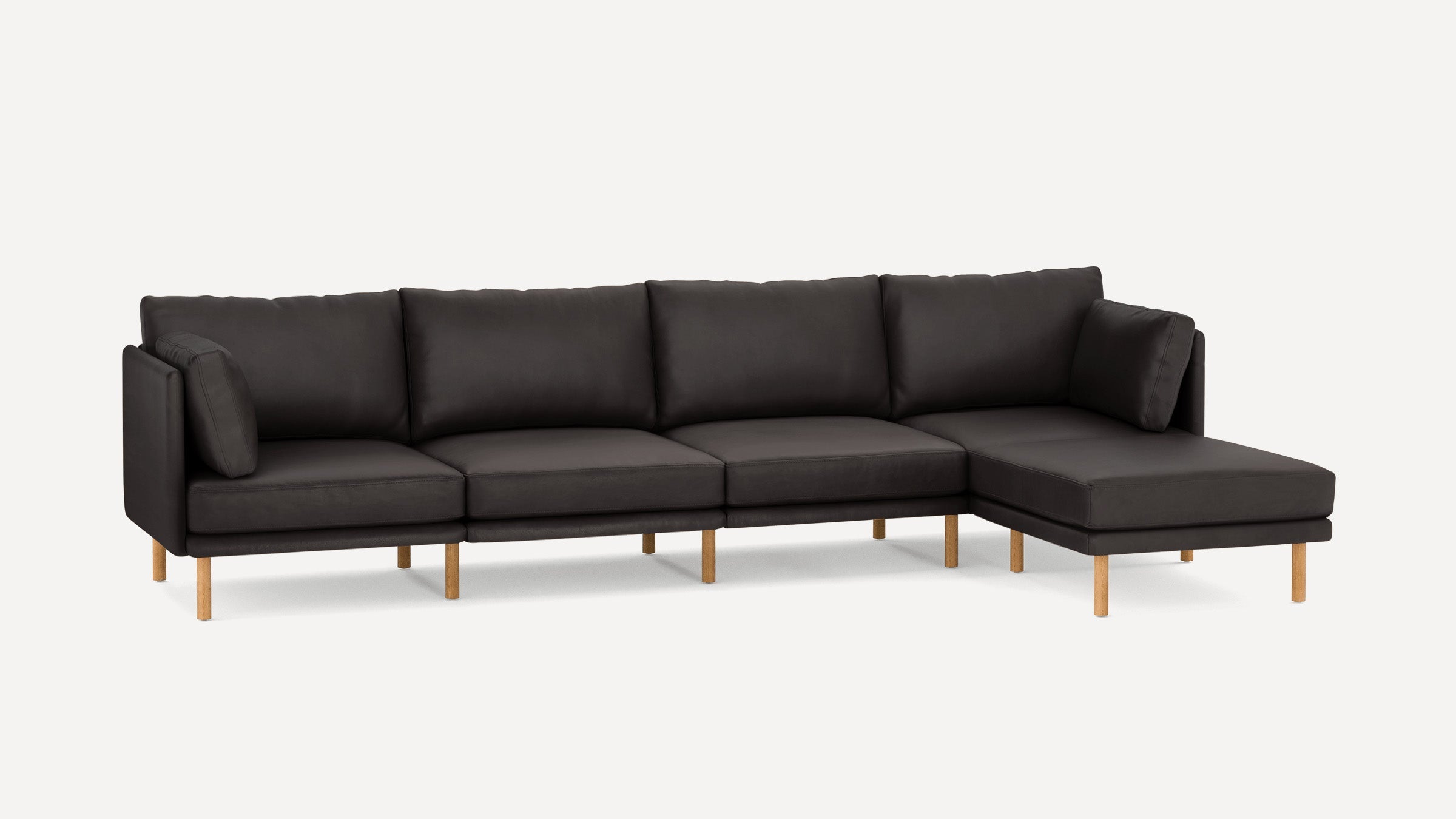 Modern dark gray sectional sofa with wooden legs, featuring a chaise lounge on the right side and plush cushions.