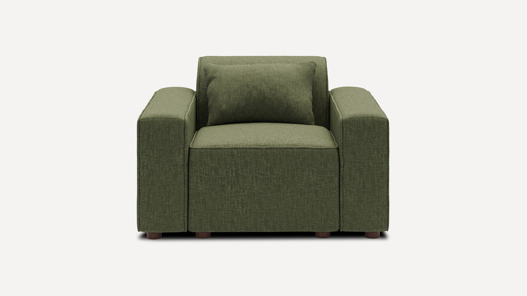 Green upholstered armchair with thick square arms, wide seat cushion, matching back cushion, and short wooden legs.