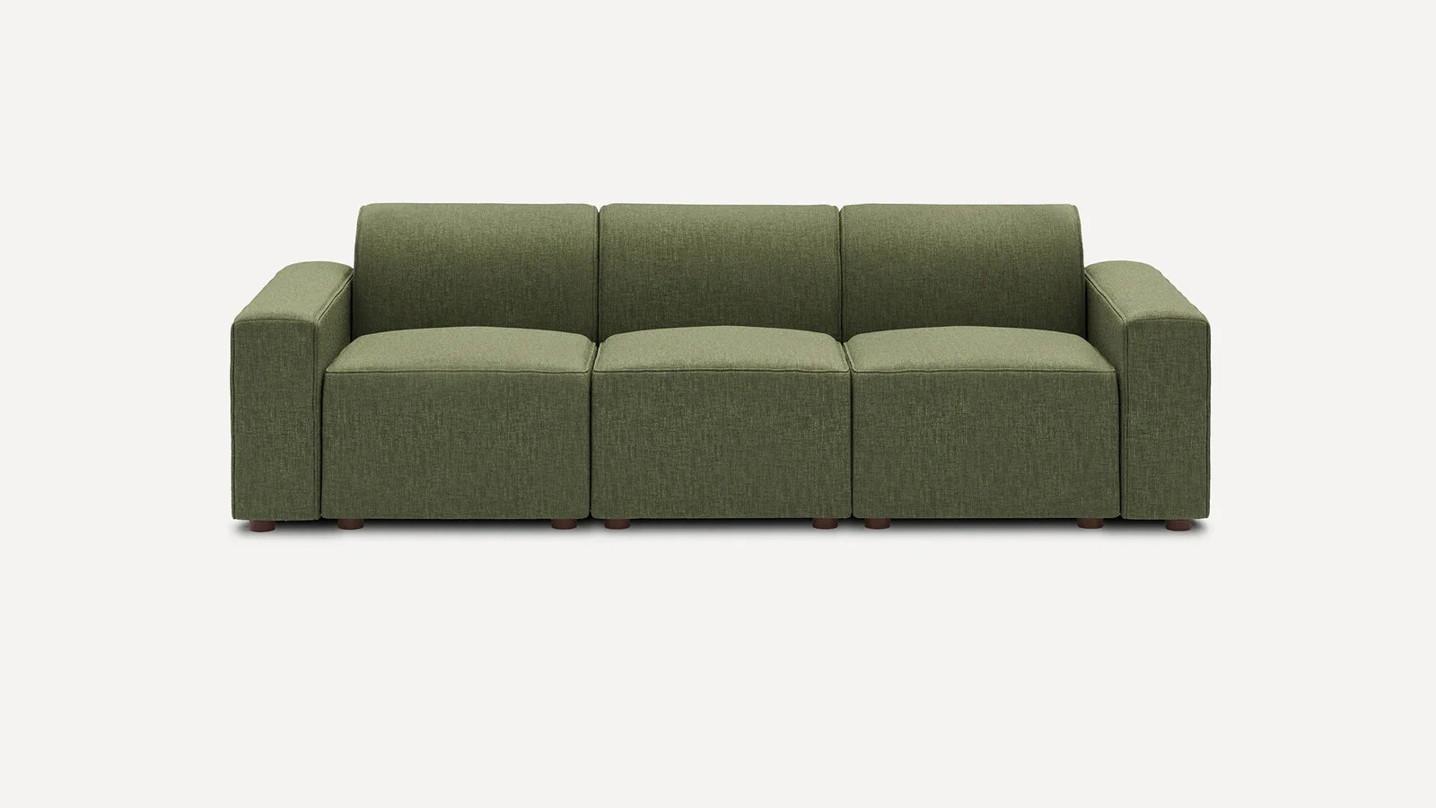 Three-seater sofa with deep green fabric upholstery, boxy design, wide armrests, and low wooden legs against plain background.