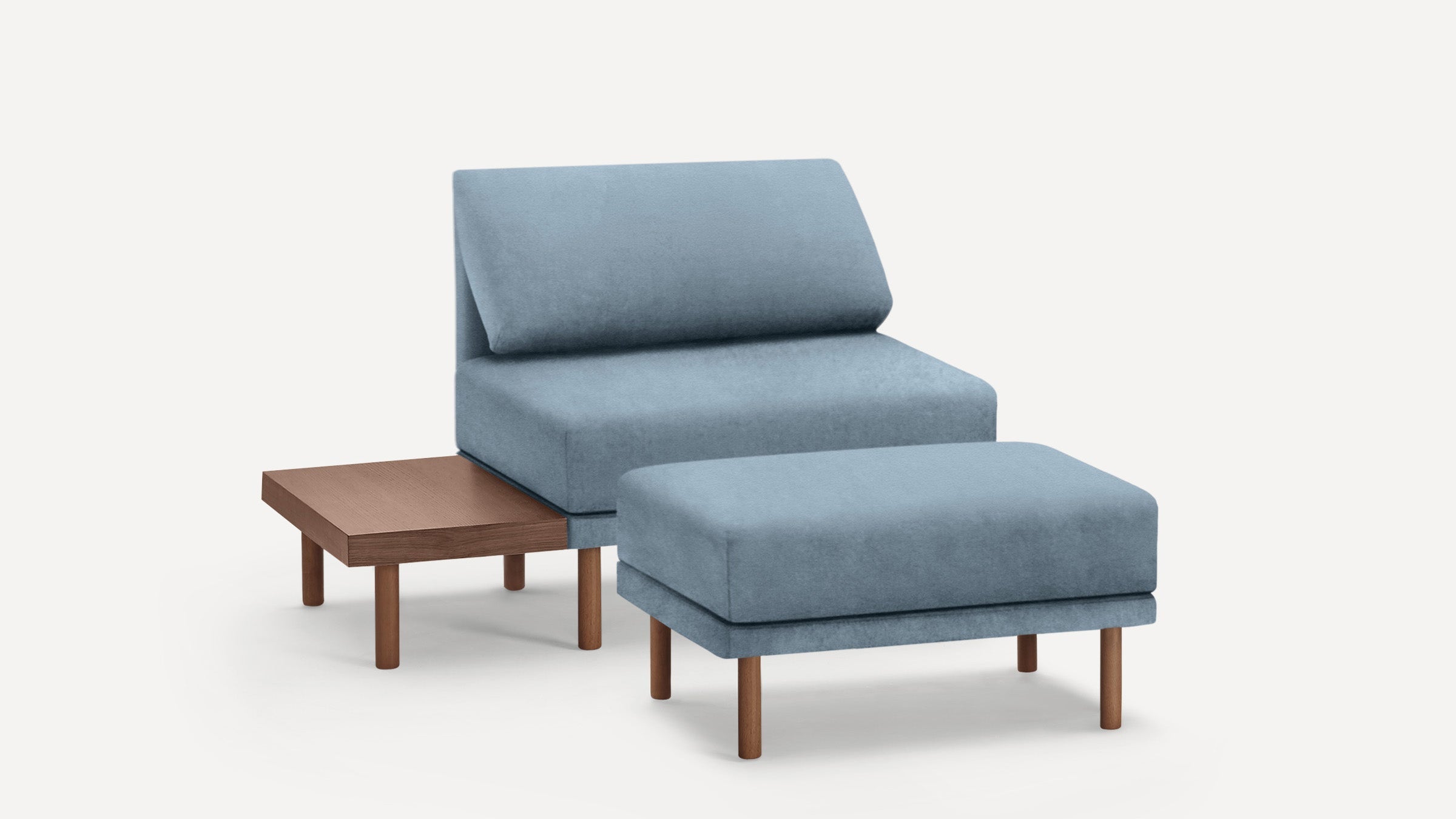 Light blue upholstered chair with matching ottoman and attached wooden side table, featuring clean lines and wooden legs.