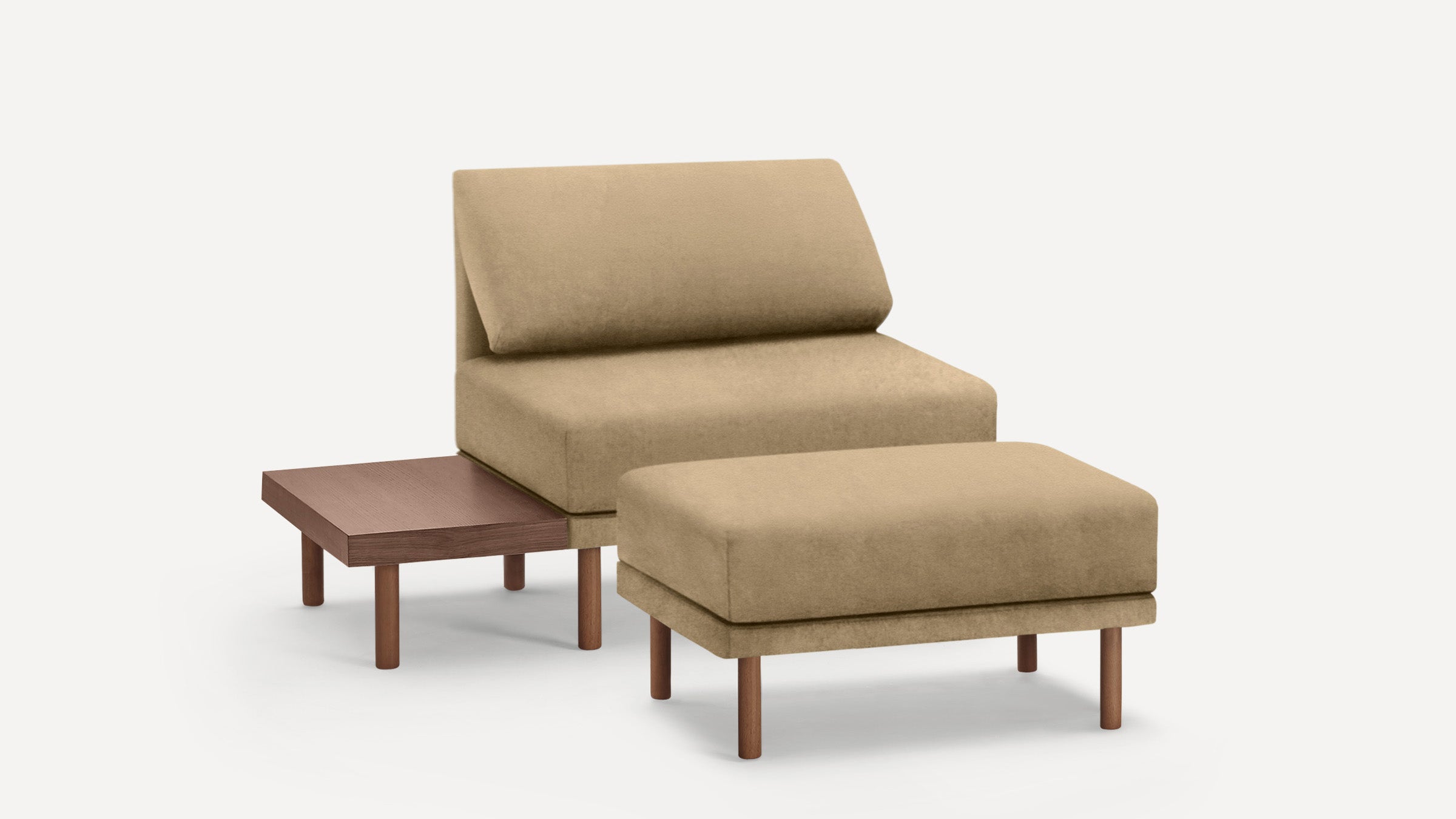 Beige upholstered armless lounge chair with matching ottoman and attached wooden side table, set on wooden legs.