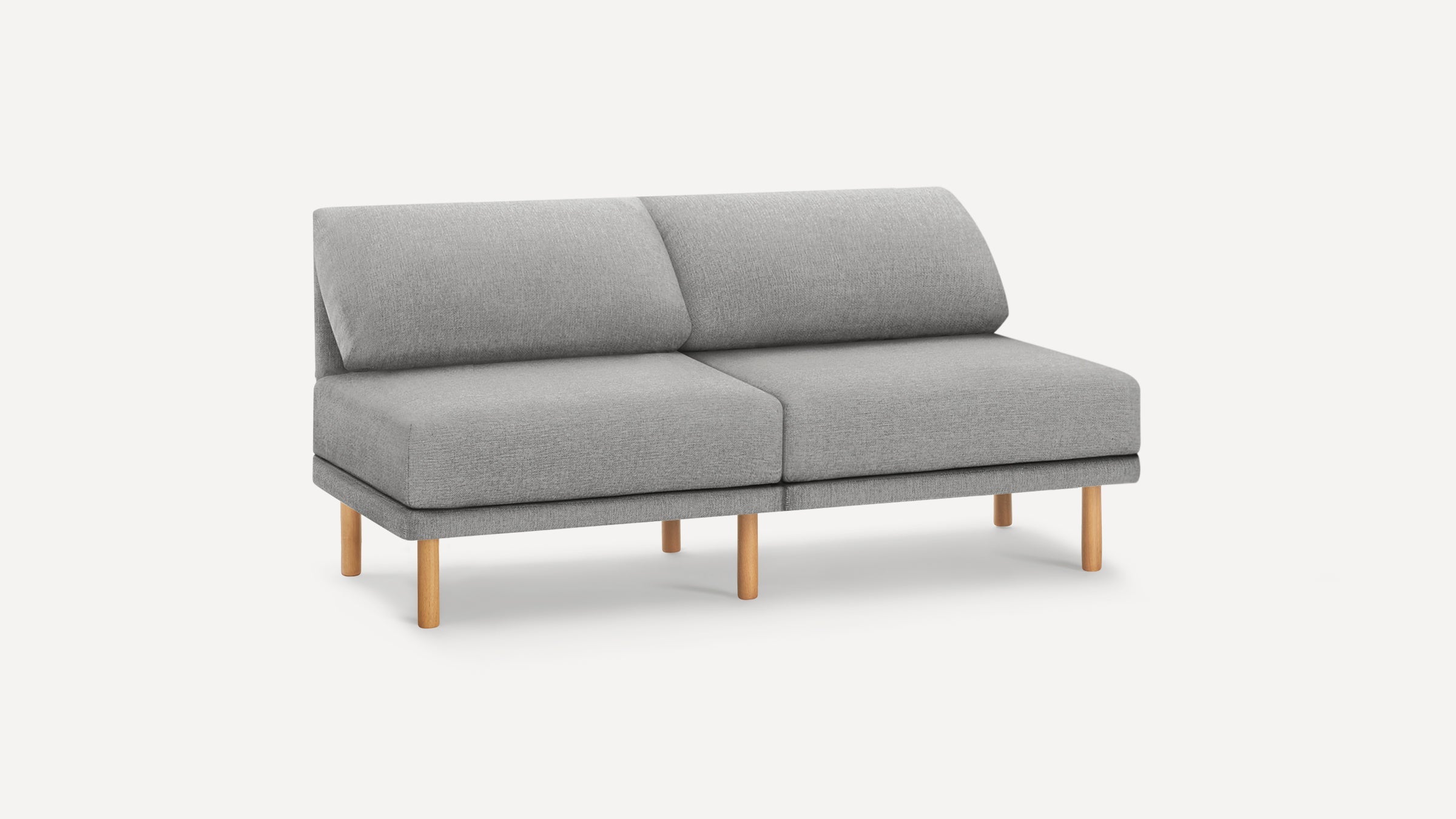 Modern light gray fabric two-seater sofa with angled cushioned backrests and natural wooden legs on a white background.