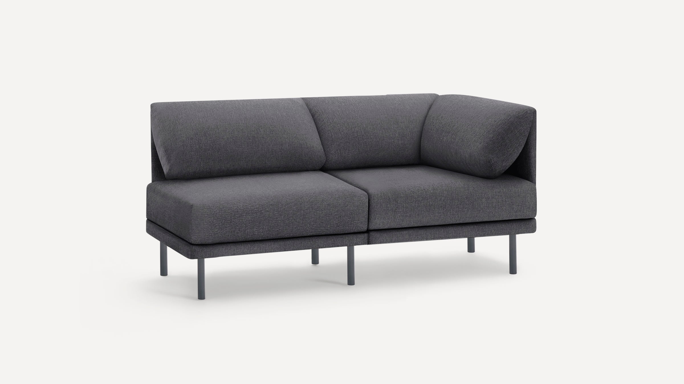 Dark gray two-seater corner sofa with soft cushions and slim metal legs, modern minimalist design.