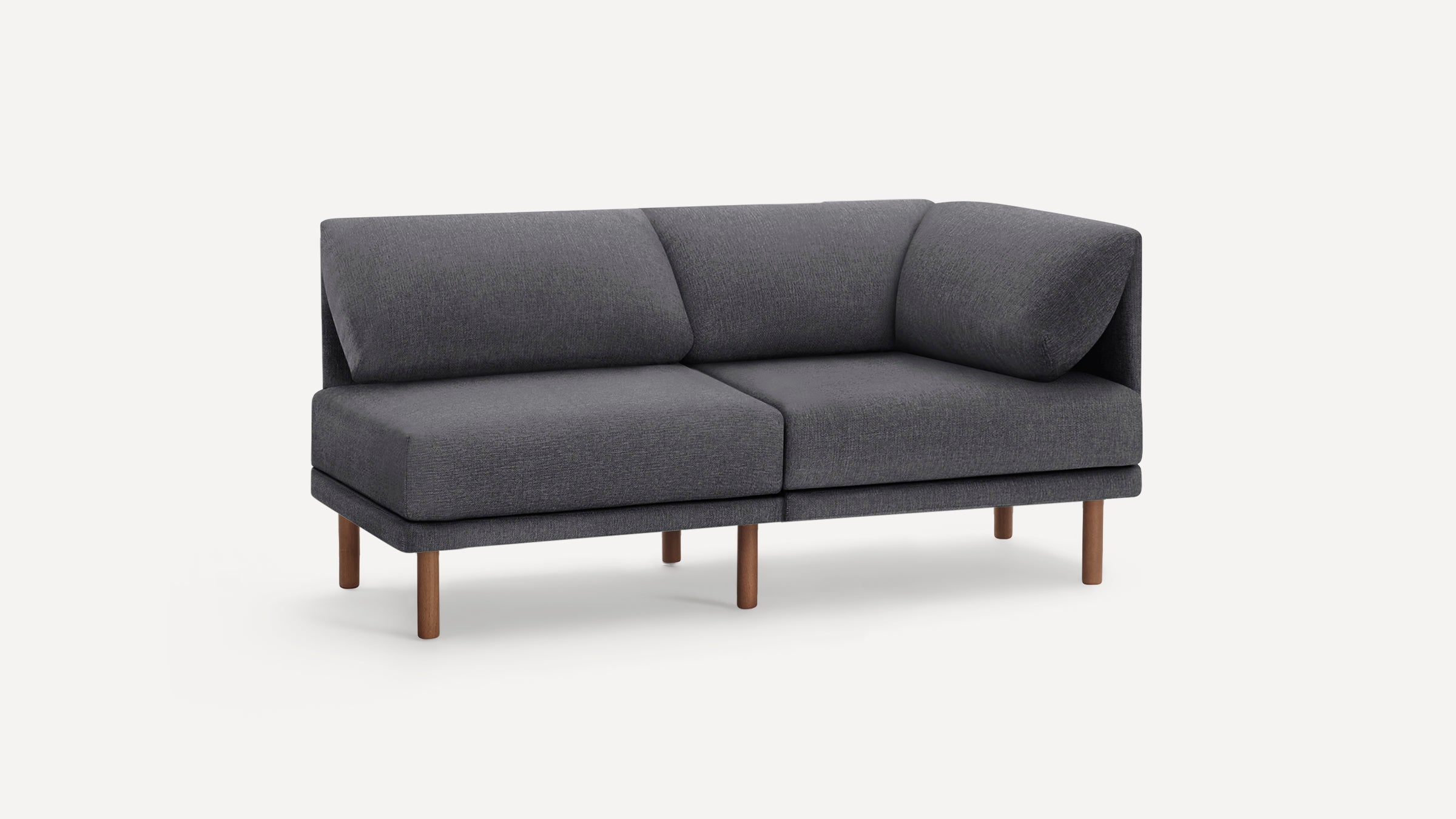 Modern dark gray fabric sectional sofa with wooden legs and plush cushions, shown on white background.