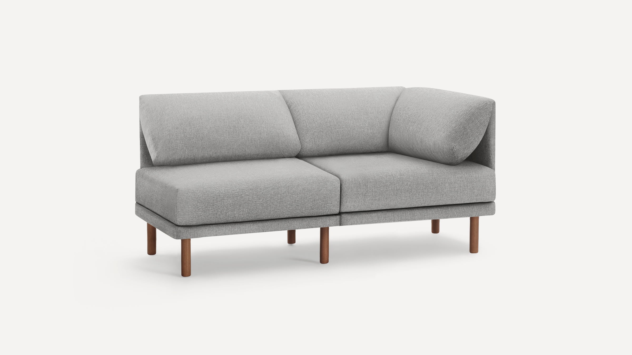 Modern light gray two-seater sofa with wooden legs and angled cushions, displayed against a plain white background.
