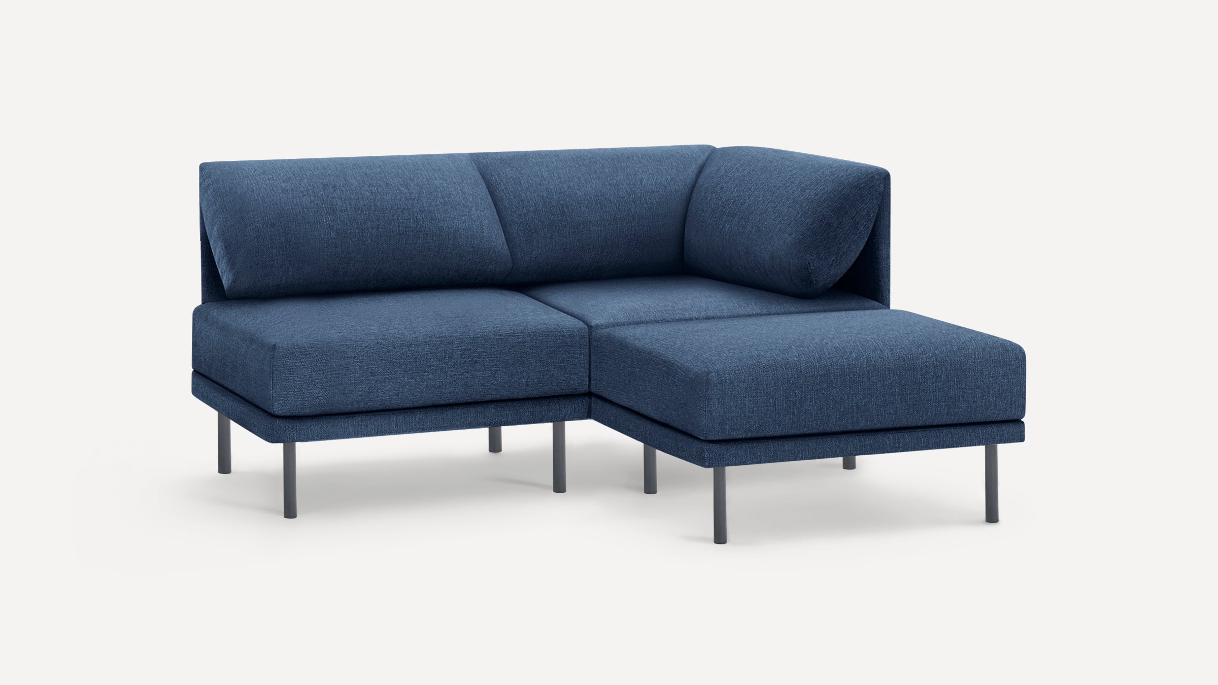 Modern L-shaped sectional sofa in deep blue fabric with sleek metal legs and cushioned backrests and seats.