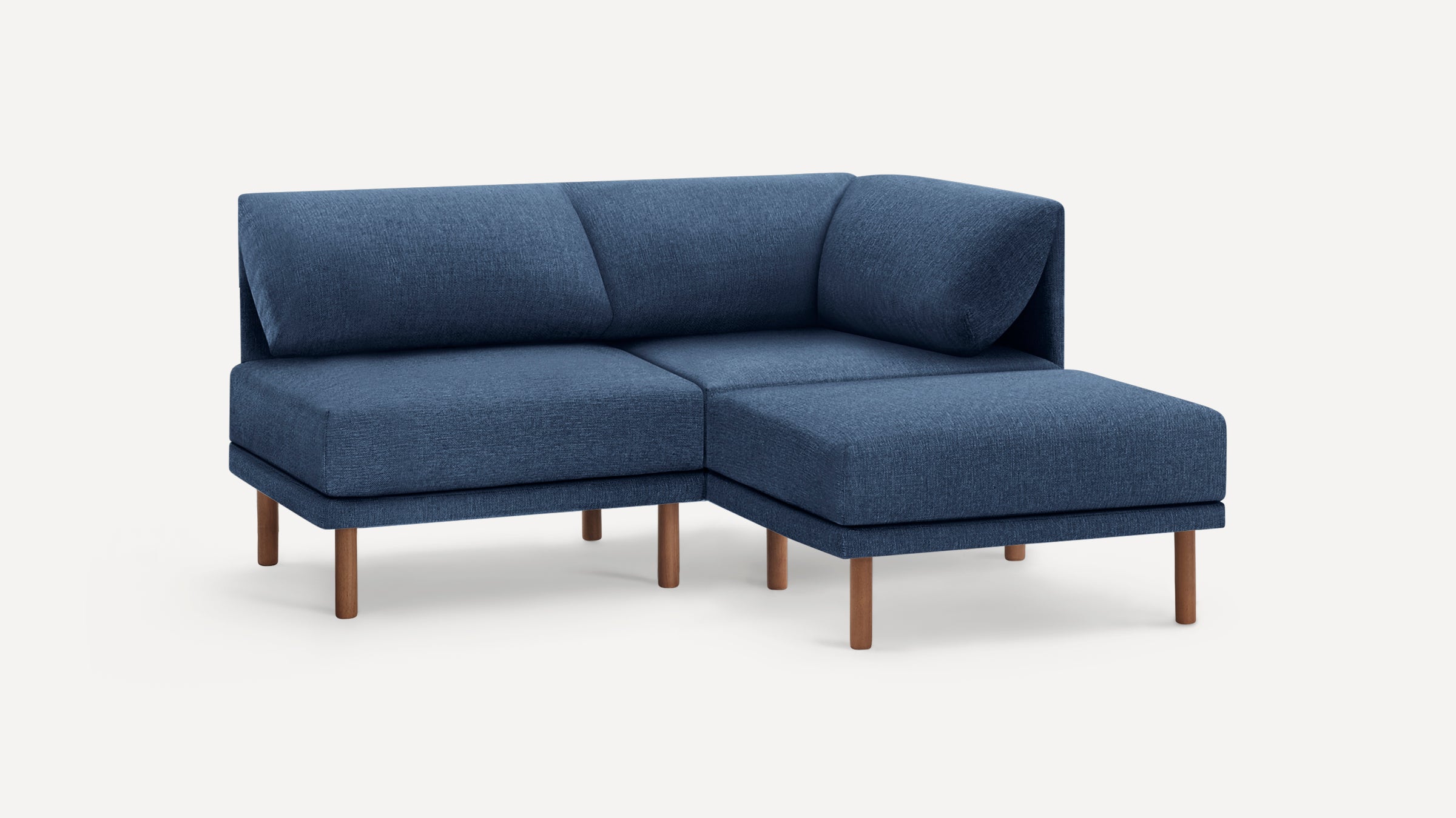 Modern blue fabric sectional sofa with wooden legs, featuring a chaise lounge on the right side.