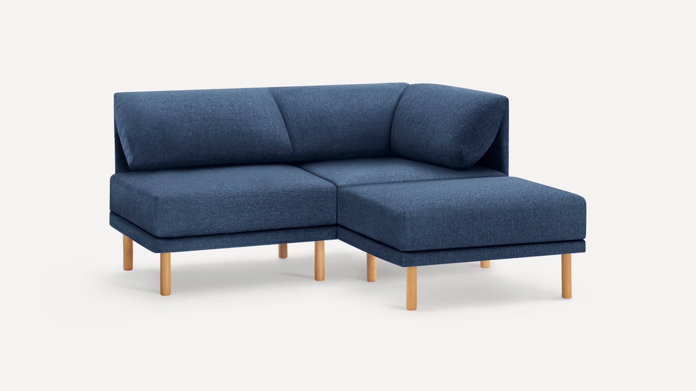 Blue fabric sectional sofa with wooden legs, featuring a right-side chaise and plush back cushions.
