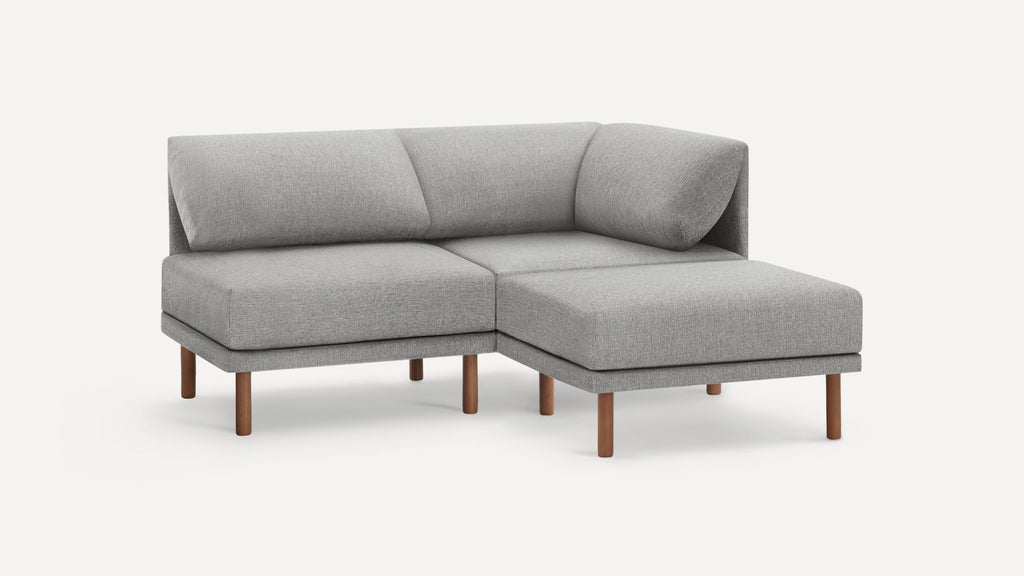 Modern L-shaped gray fabric sectional sofa with wooden legs, featuring a corner backrest and plush cushions.