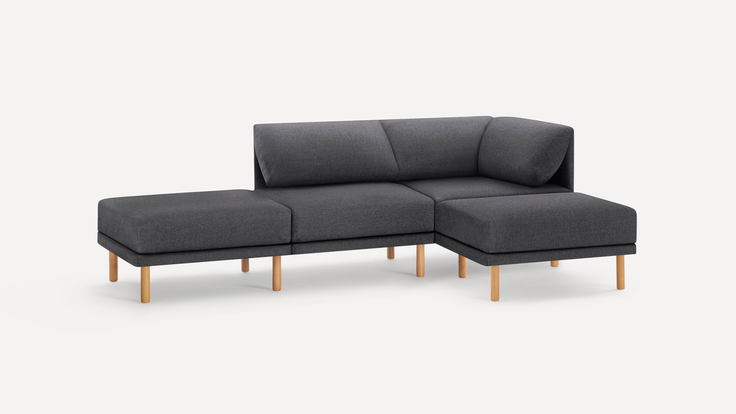 Modern dark gray L-shaped sectional sofa with wooden legs, cushioned backrests, and a minimalist design on white background.