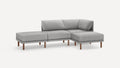 Modern light gray fabric sectional sofa with wooden legs, featuring a right-side chaise lounge and low back cushions.