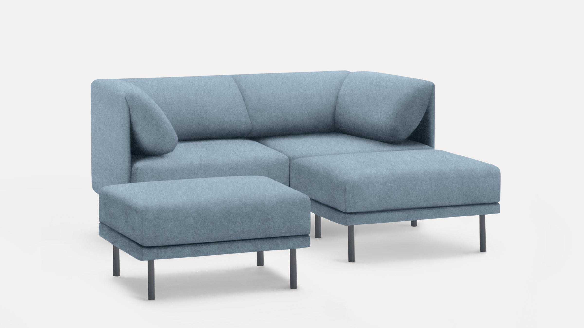 Modern light blue upholstered sectional sofa with an attached chaise and a matching ottoman, both supported by slim black legs.