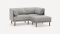 modern light gray fabric sectional sofa with wooden legs and matching ottoman, featuring a clean, minimalist design