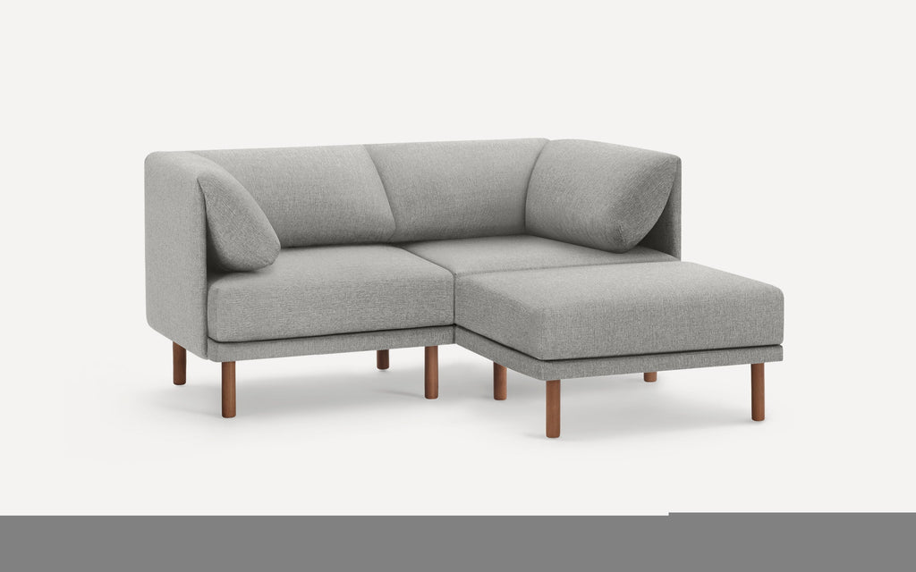 Modern light gray fabric sectional sofa with wooden legs, featuring a right-side chaise and cushioned armrests.