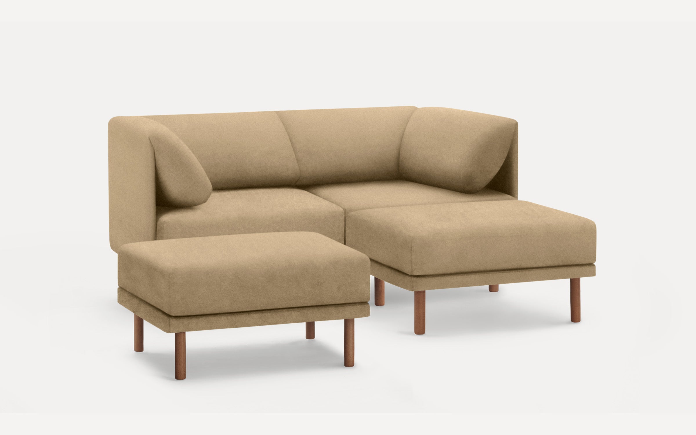 Beige L-shaped sectional sofa with plush cushions and matching ottoman, both featuring wooden legs on a white background.