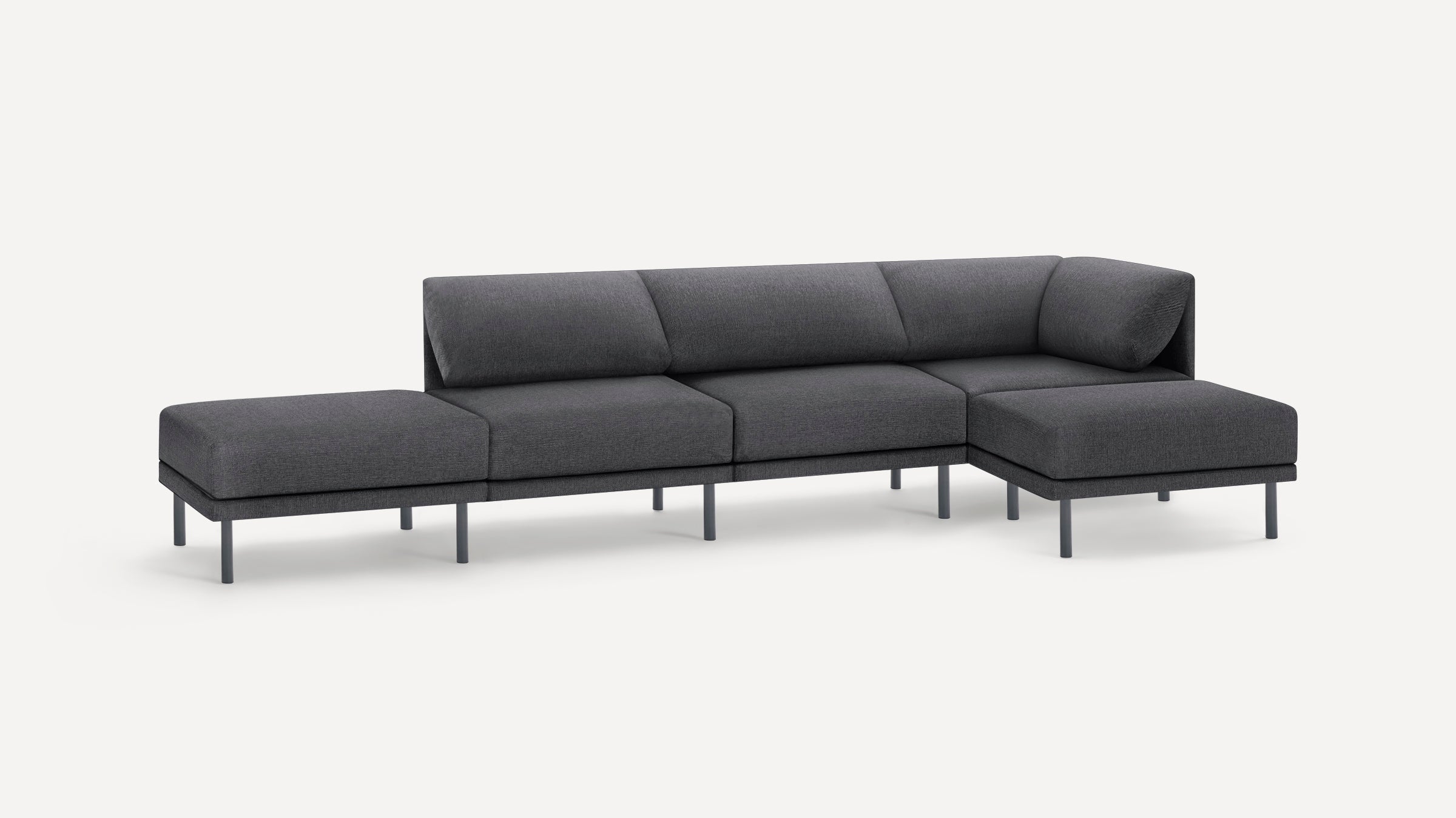 Modern dark gray sectional sofa with sleek thin legs, composed of four seating sections including a corner piece and an ottoman.