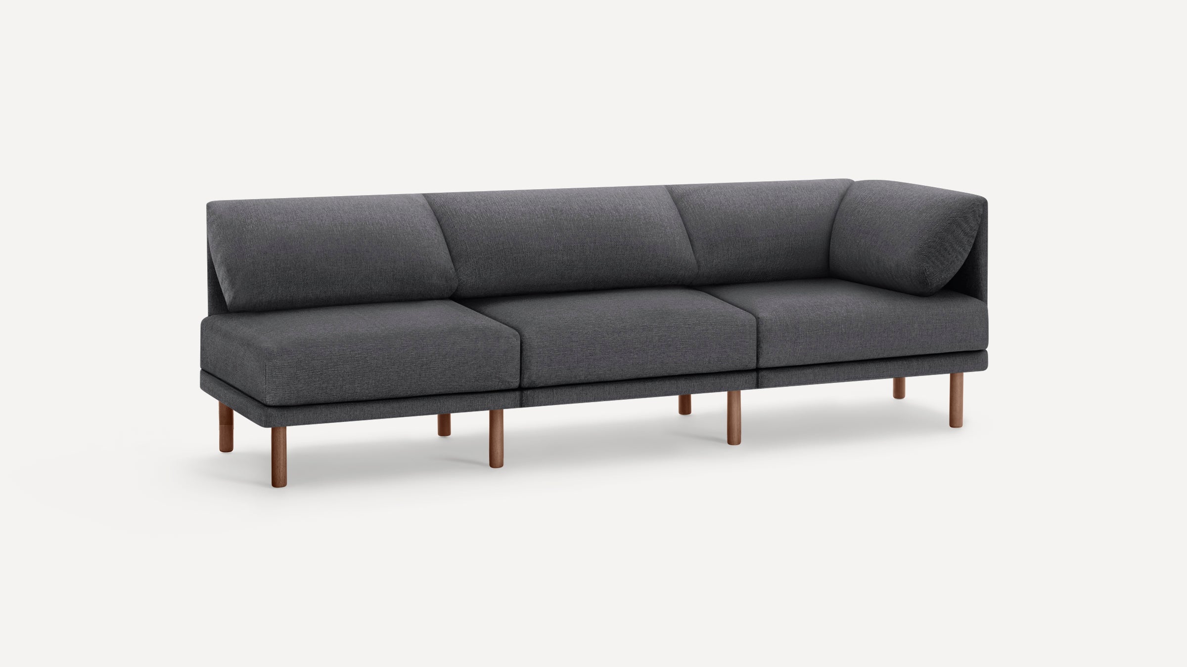 Modern dark gray fabric sectional sofa with clean lines and wooden legs, featuring an angled corner cushion for comfort.