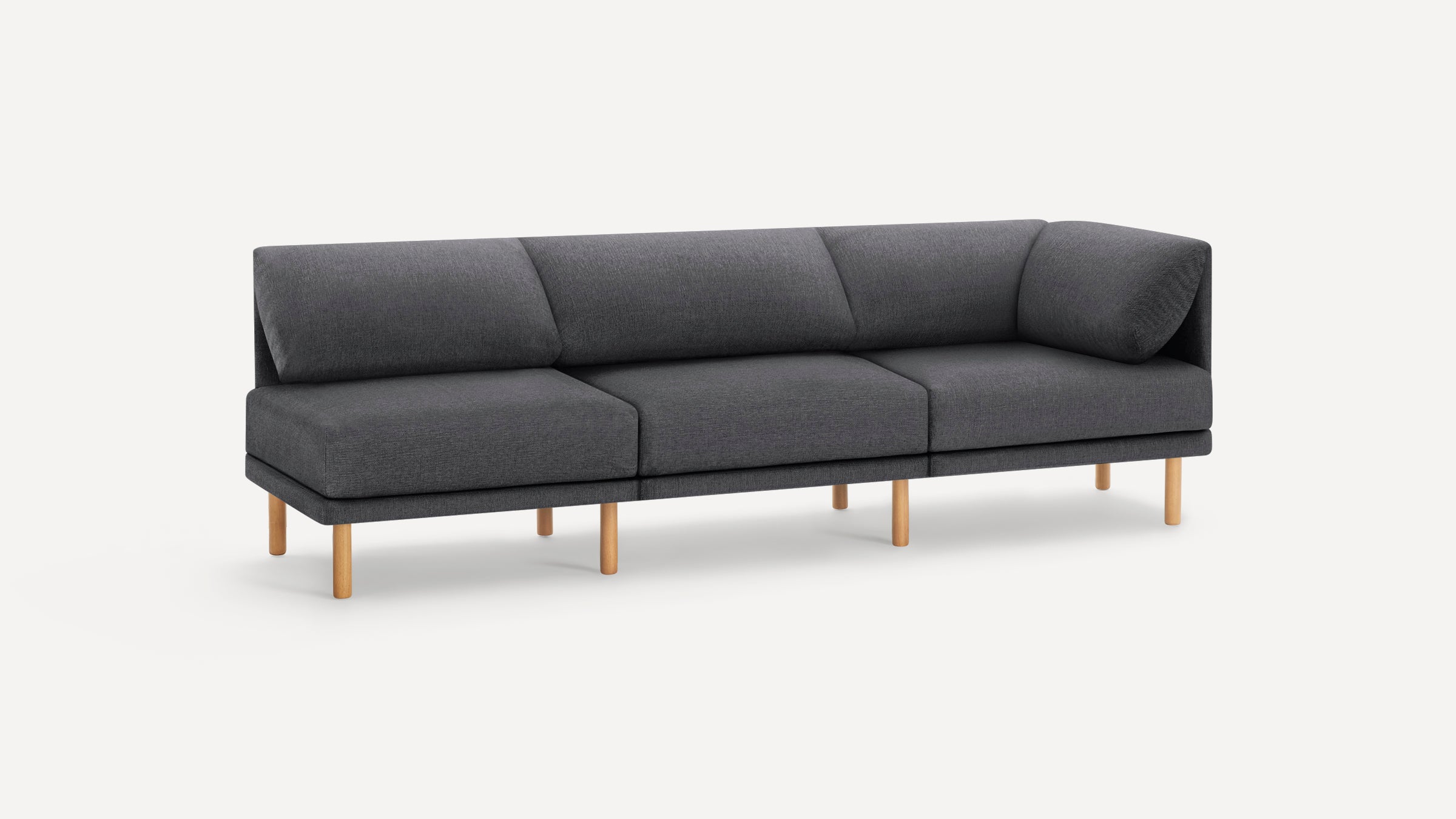 Modern dark gray fabric sectional sofa with wooden legs, featuring a minimalist design and angled back cushions.