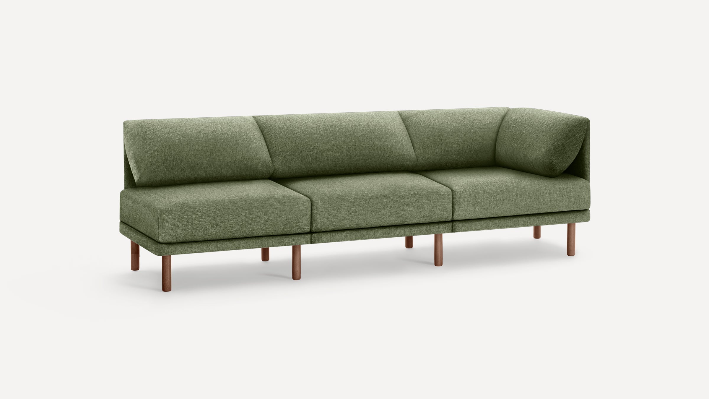 Modern three-seater green fabric sofa with angled back cushions and wooden legs, on a plain white background.
