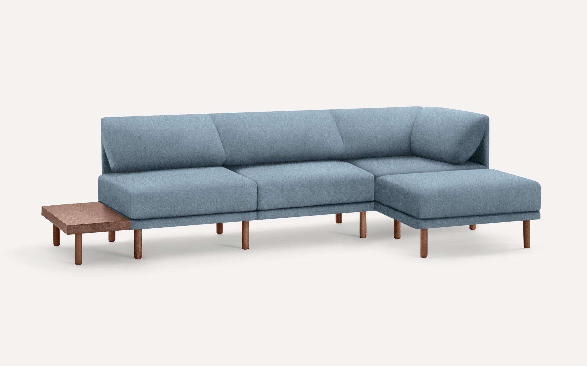 modern light blue sectional sofa with wooden legs and matching ottoman, featuring a clean, minimal design