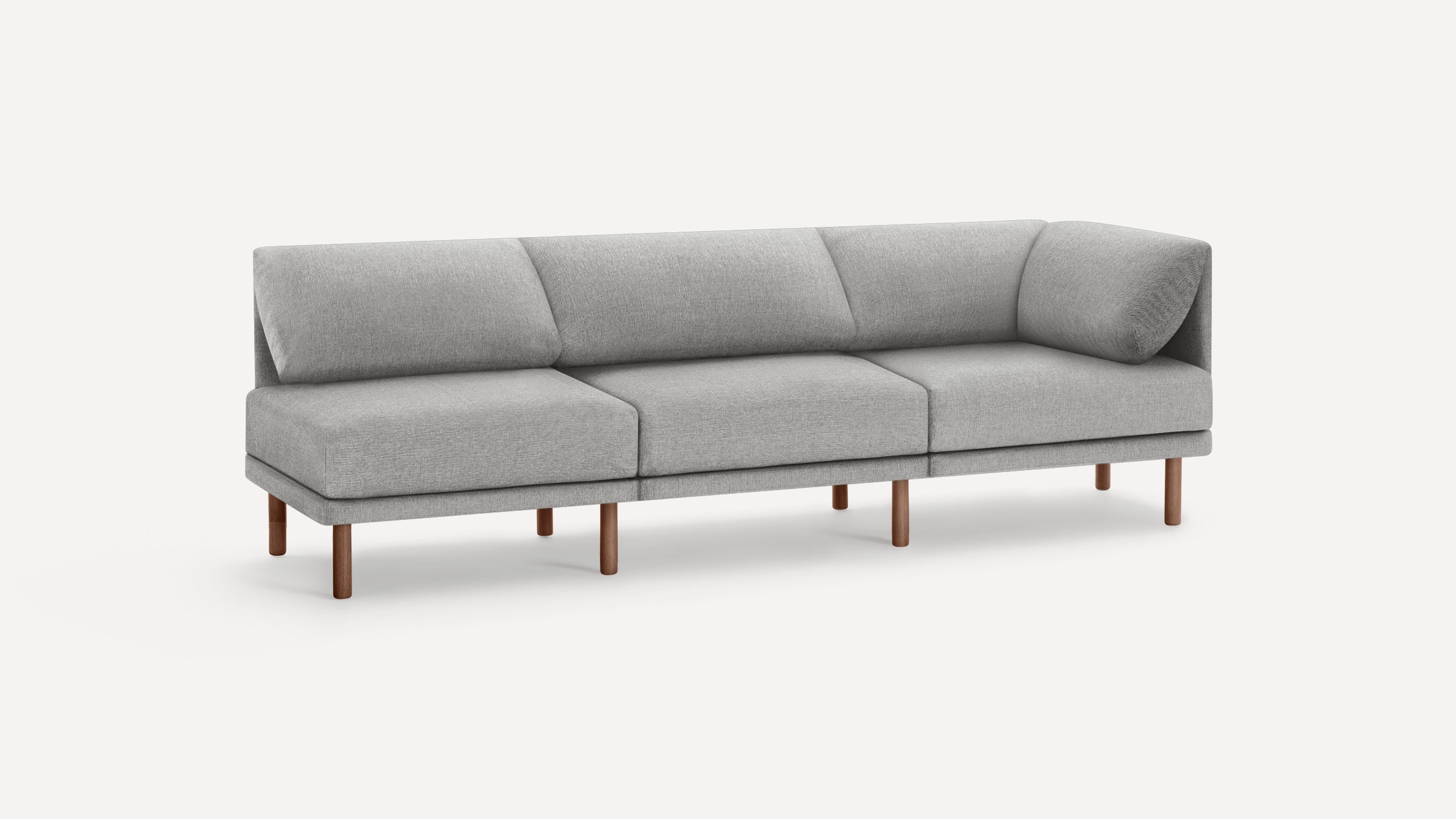 Modern light gray fabric sectional sofa with wooden legs and angled back cushions on a plain white background.