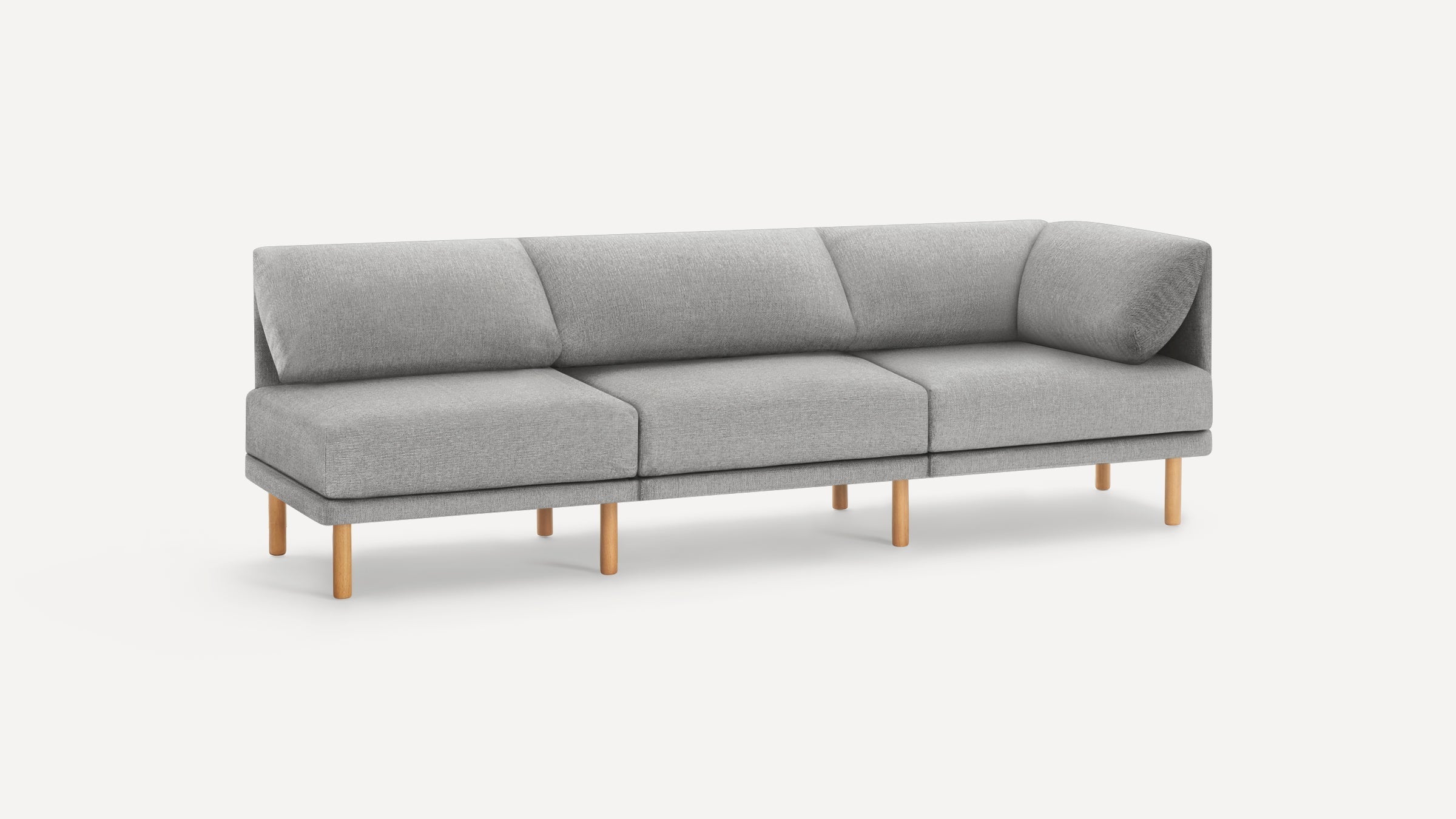 Modern light gray fabric sectional sofa with wooden legs, three seat cushions, and back cushions on a white background.