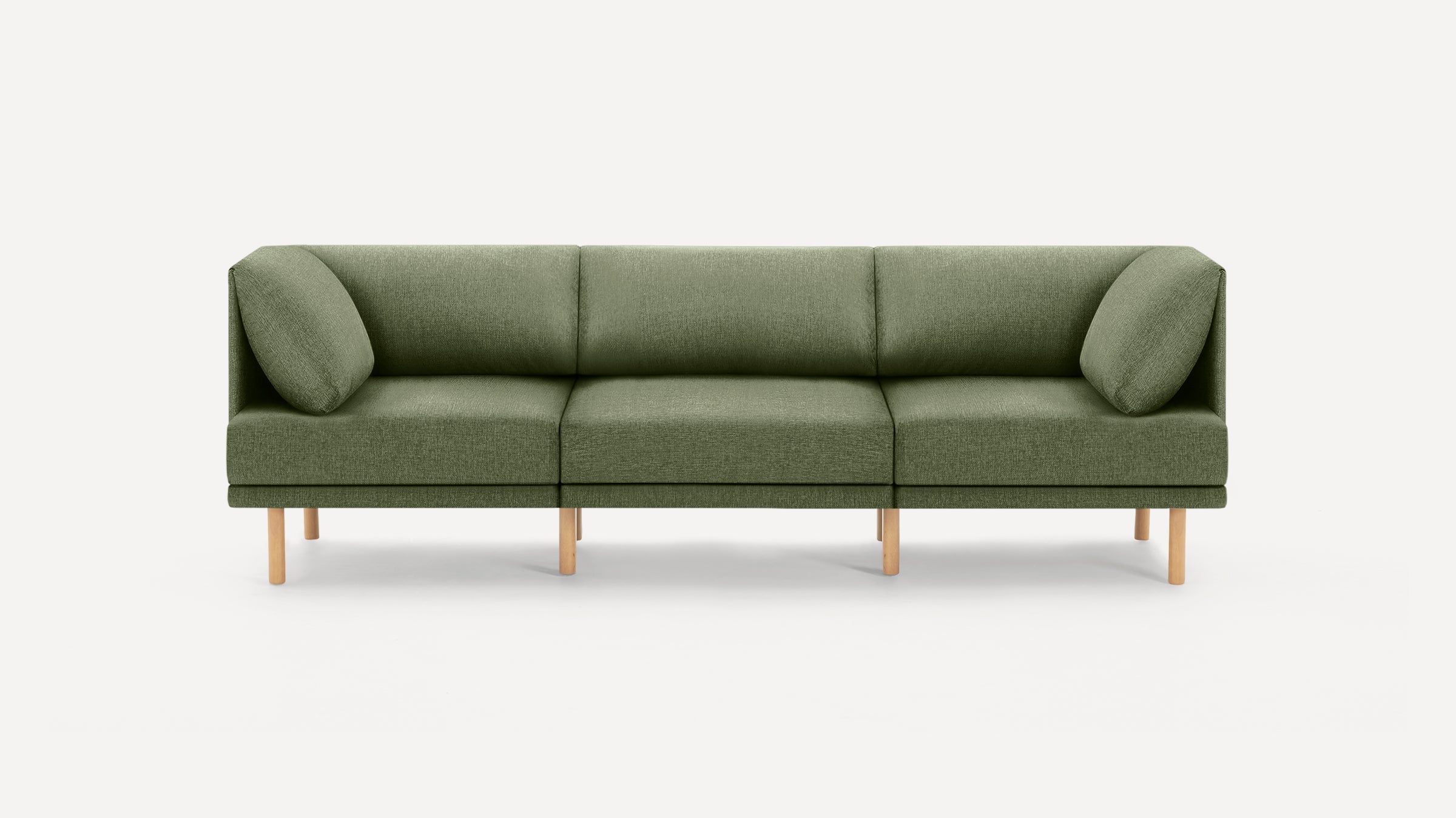 Modern olive green three-seater sofa with wooden legs, clean lines, and matching angled square cushions on each end.