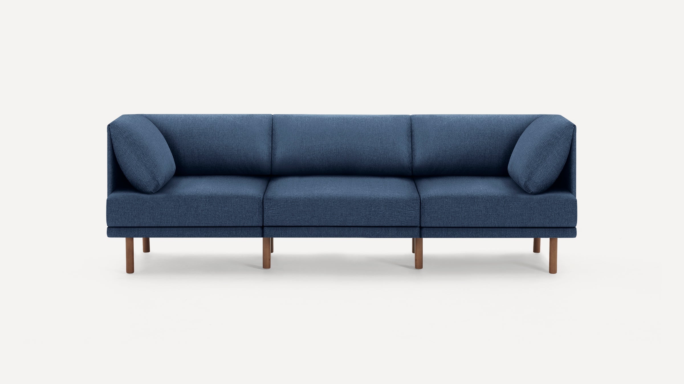 Modern three-seat sofa with blue fabric upholstery and wooden legs on a white background.