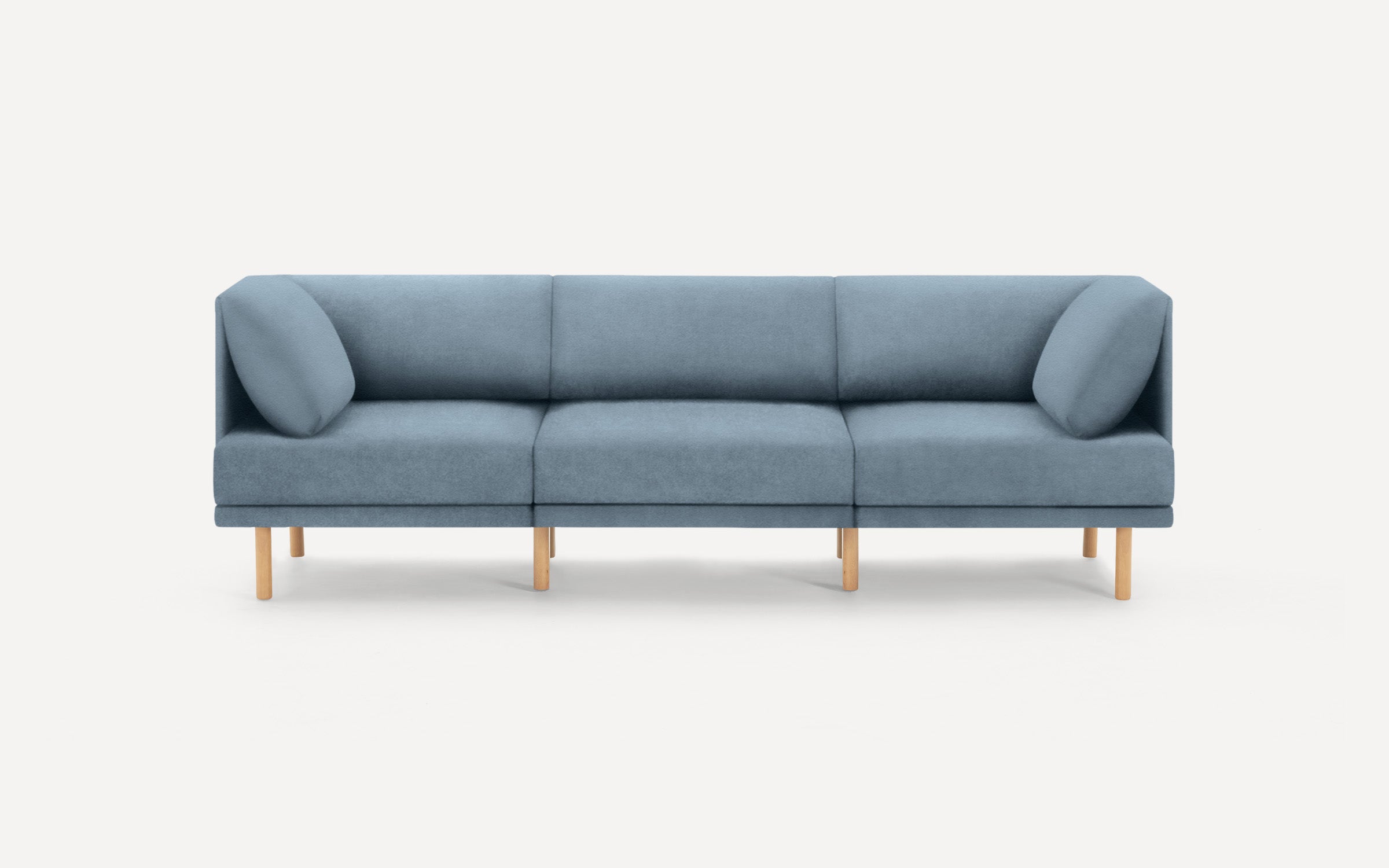 modern blue fabric sofa with wooden legs and clean lines on a white background