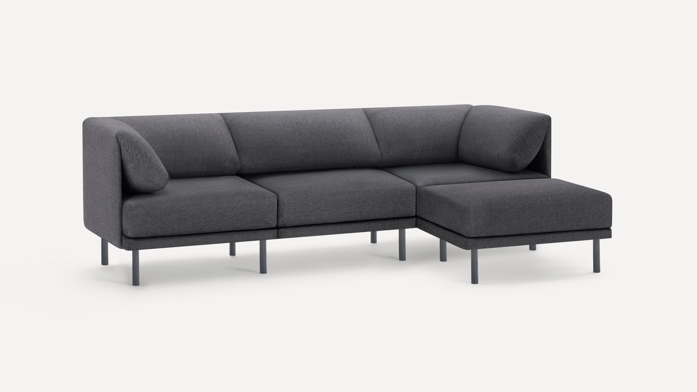 Modern dark gray L-shaped sectional sofa with low backrest, clean lines, and metal legs on white background.