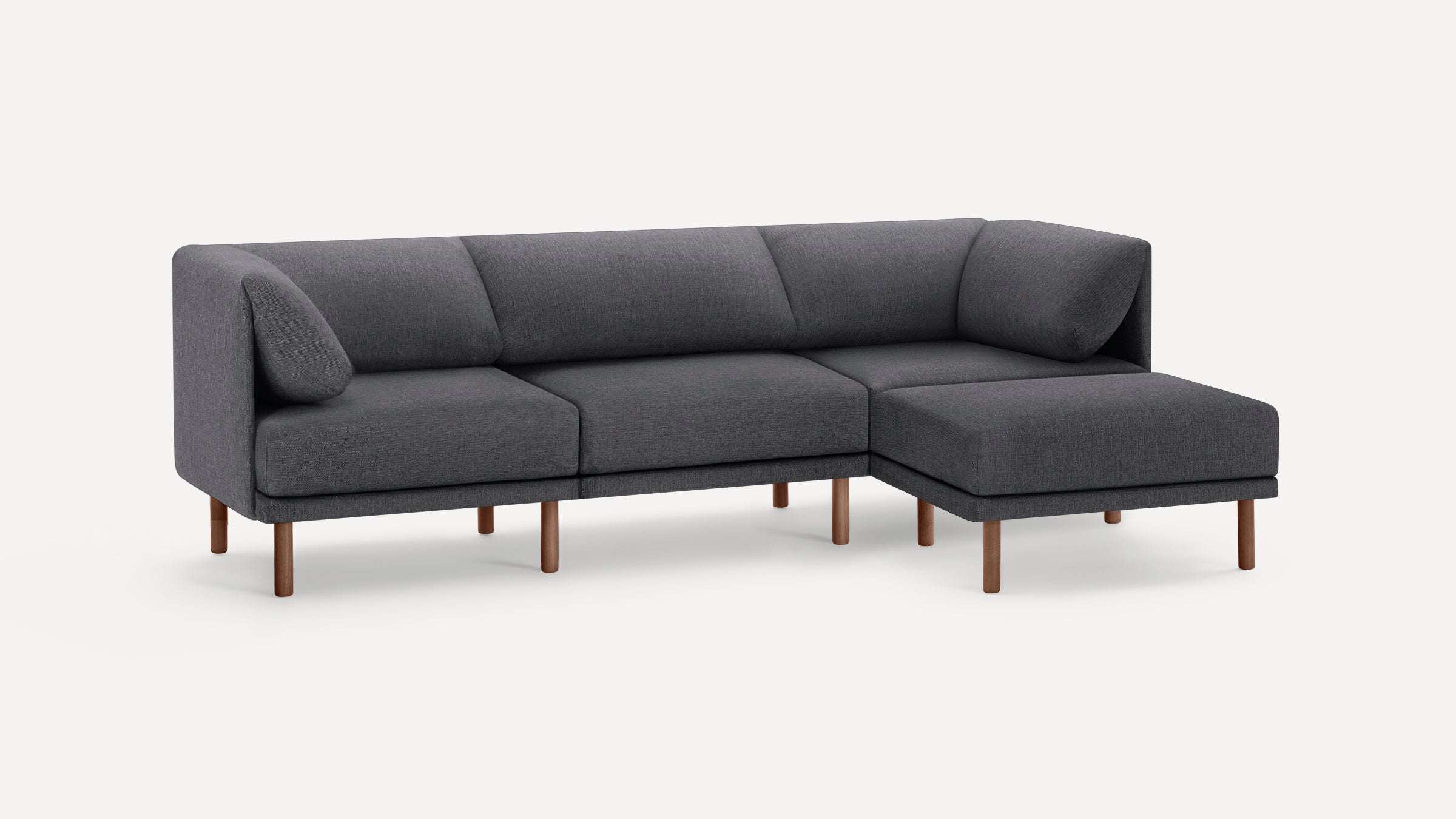 Modern dark gray sectional sofa with wooden legs, featuring an L-shape design and two angled cushions for back support.