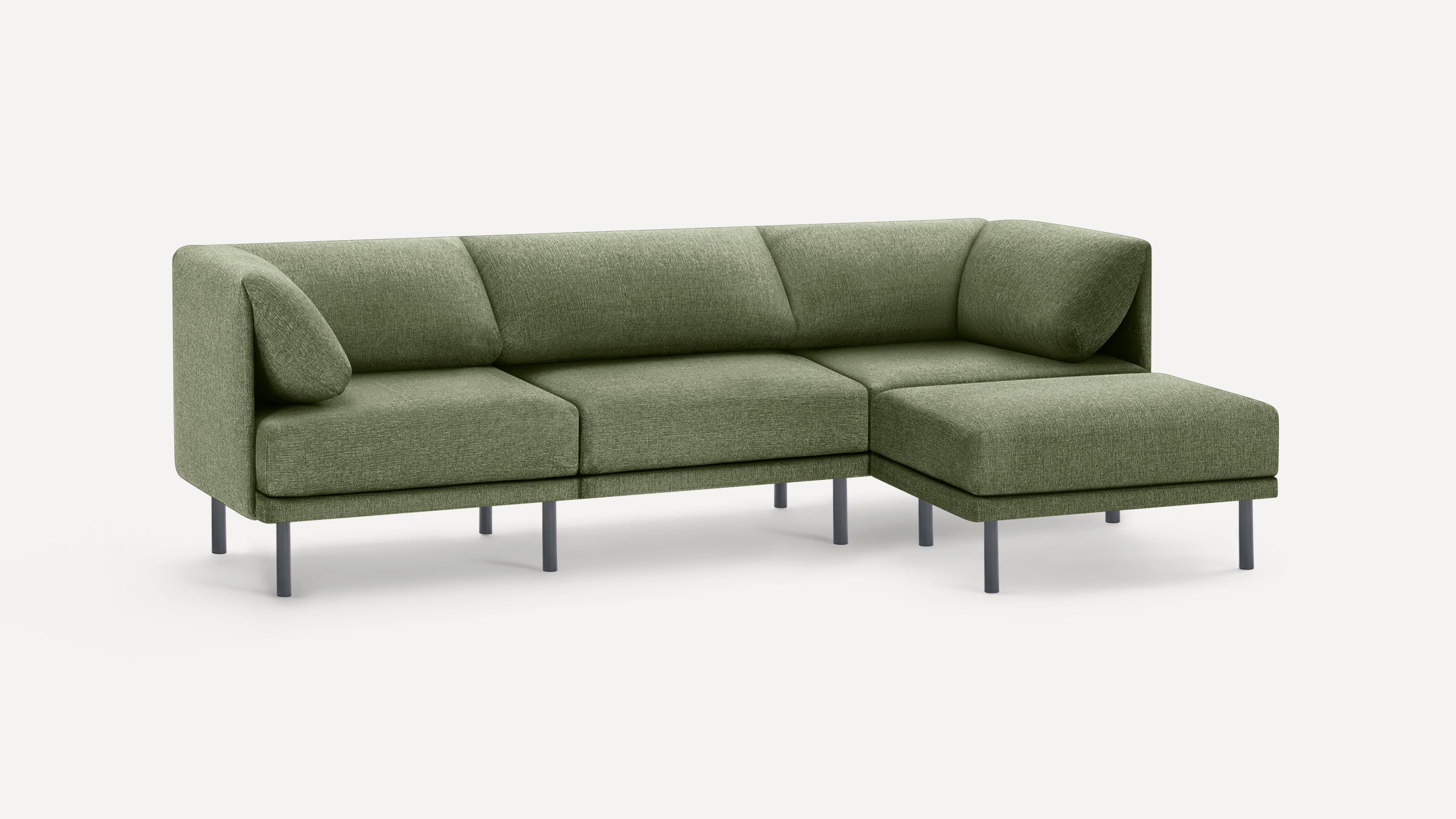 Modern L-shaped green fabric sofa with metal legs, featuring firm cushions and a chaise lounge on the right side.