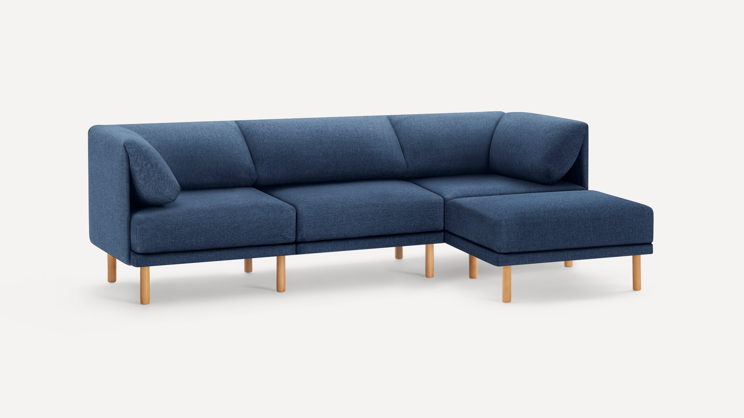 Modern L-shaped sectional sofa in blue fabric with wooden legs, featuring clean lines and comfortable cushions.