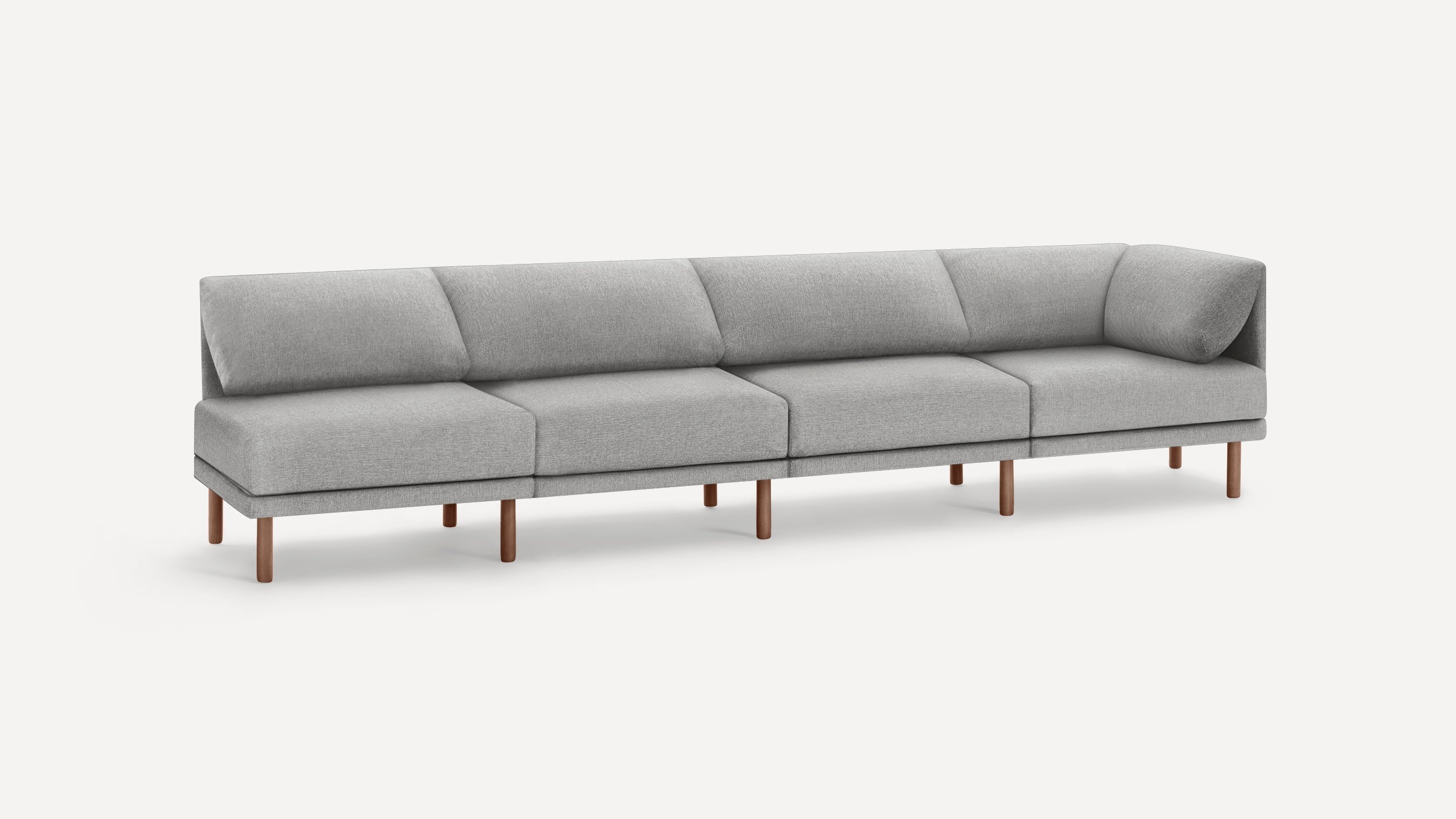 Modern light gray sectional sofa with angled backrests and wooden legs, designed for spacious seating comfort.