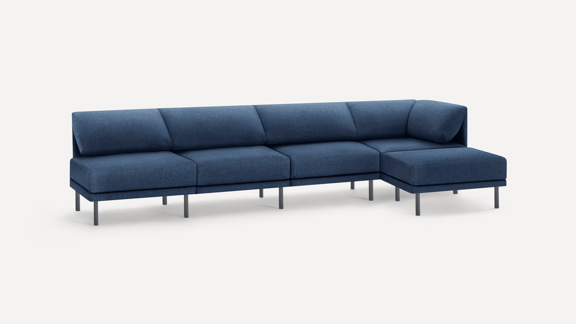 Modern navy blue sectional sofa with four seats and a chaise lounge, featuring slim black legs and minimalist design.