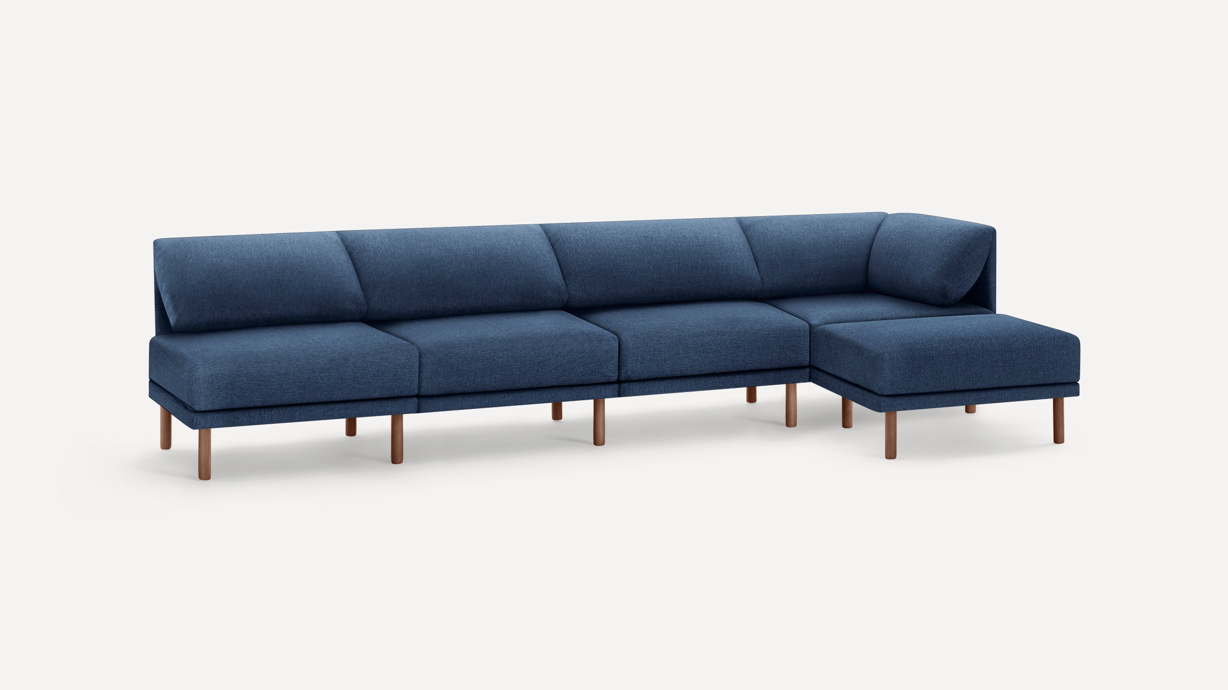 Modern L-shaped sectional sofa with deep blue fabric upholstery and wooden legs, featuring five-seat cushions and a chaise lounge on the right side.