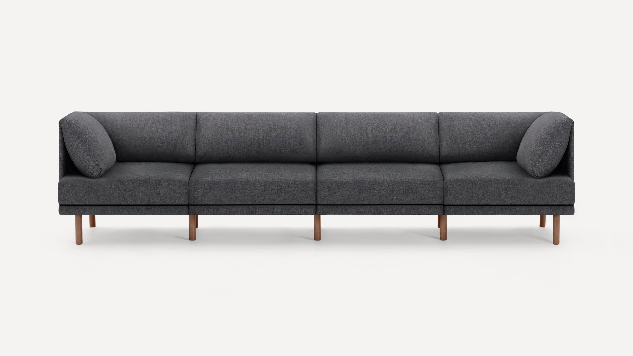 Modern gray fabric sectional sofa with wooden legs, featuring clean lines and angled arm cushions.